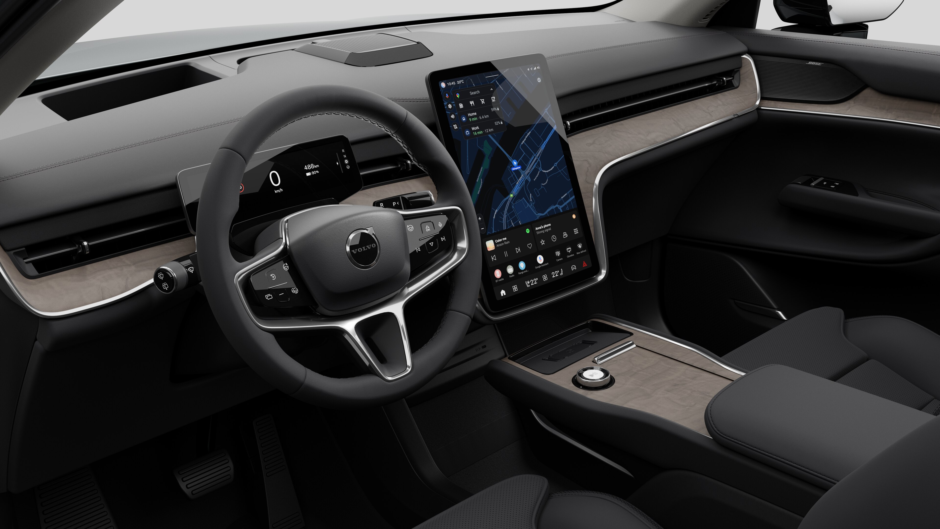 Interior view of a Volvo car showing the dashboard, steering wheel, center console, and digital display screen in a plain studio background.