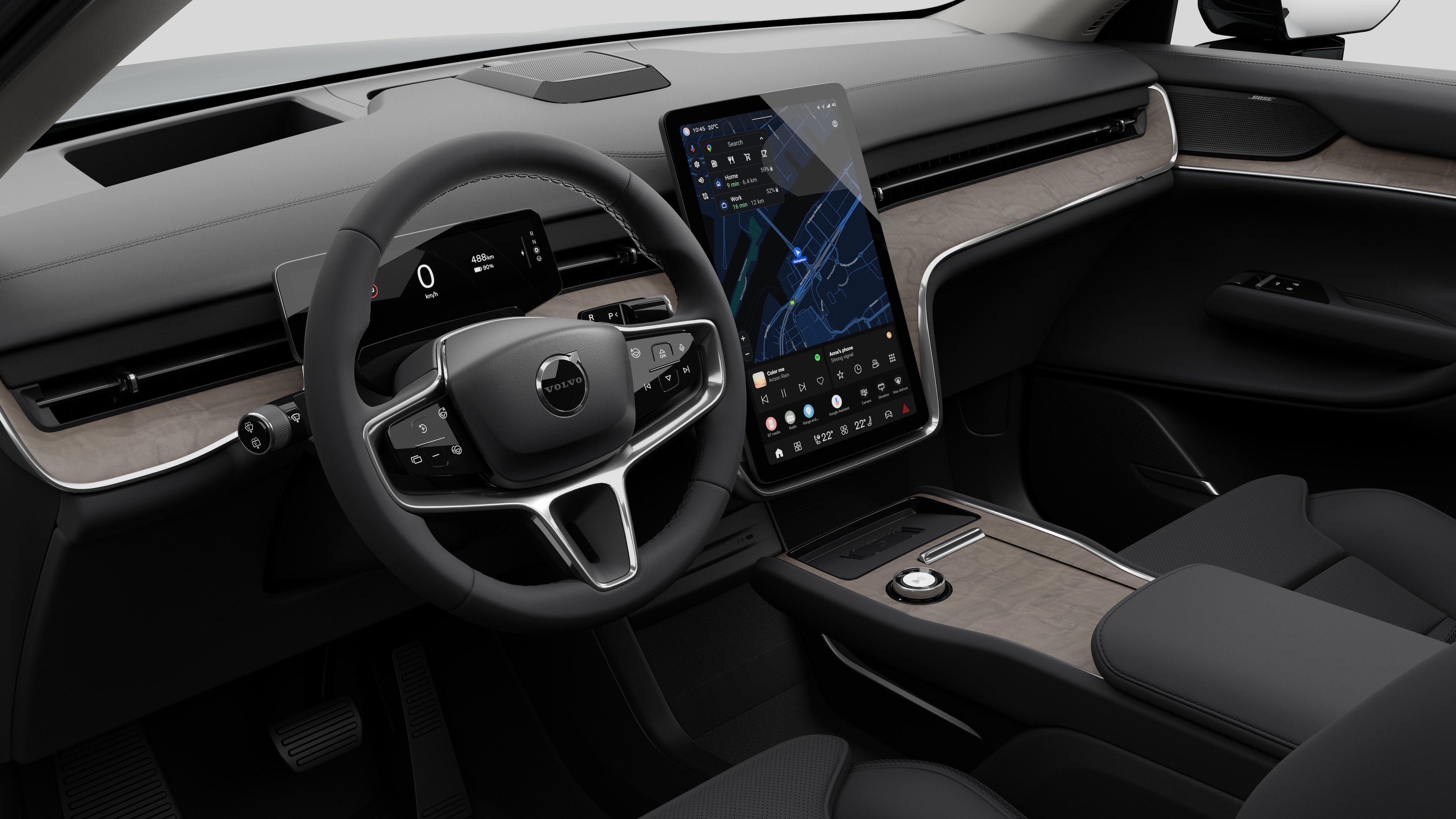 Interior view of a Volvo car showing the dashboard, steering wheel, center console, and digital display screen in a plain studio background.