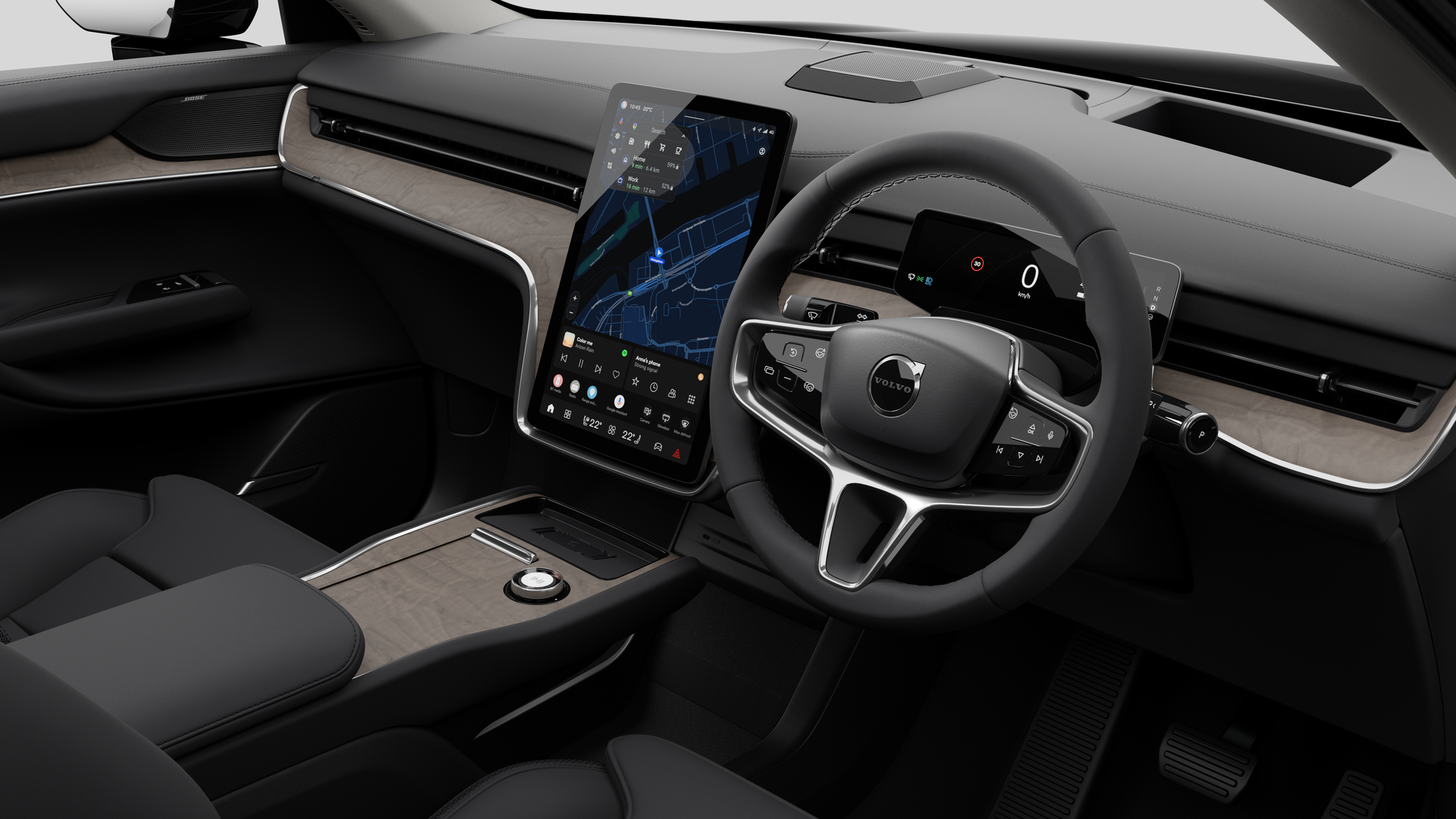 Interior view of a Volvo car showing the dashboard, steering wheel, center console, and digital display screen in a plain studio background.