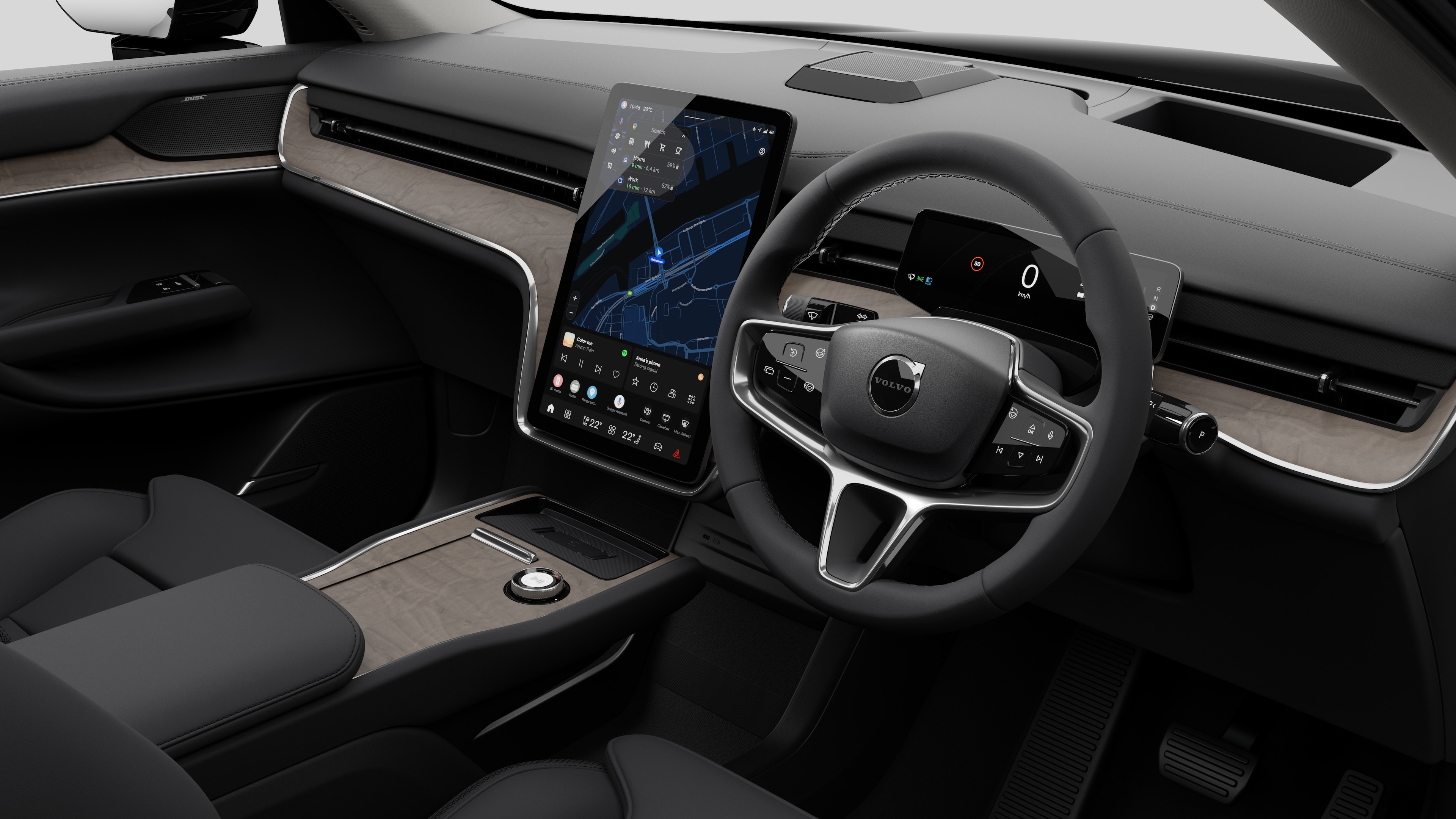 Interior view of a Volvo car showing the dashboard, steering wheel, center console, and digital display screen in a plain studio background.
