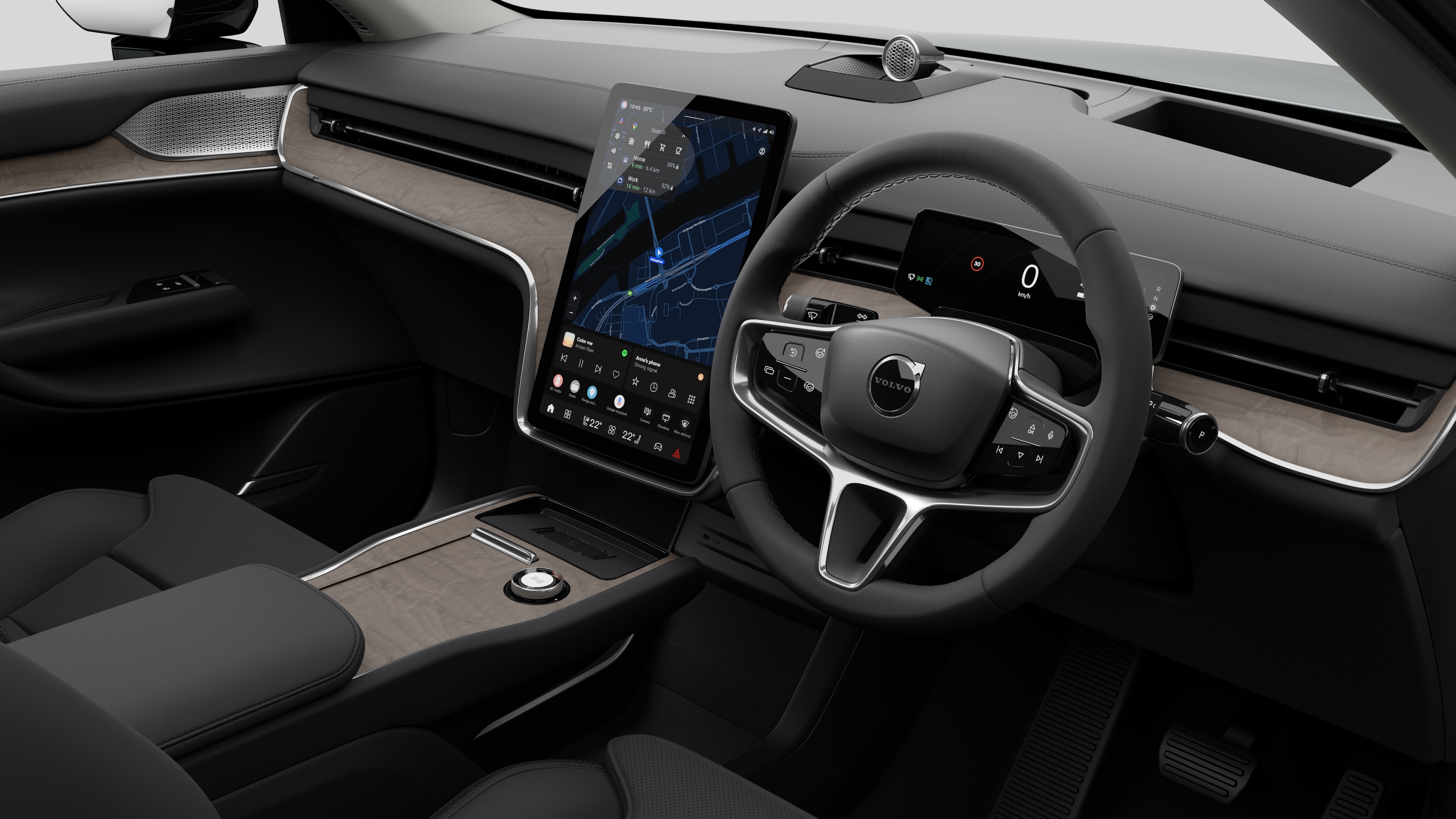 Interior view of a Volvo car showing the dashboard, steering wheel, center console, and digital display screen in a plain studio background.