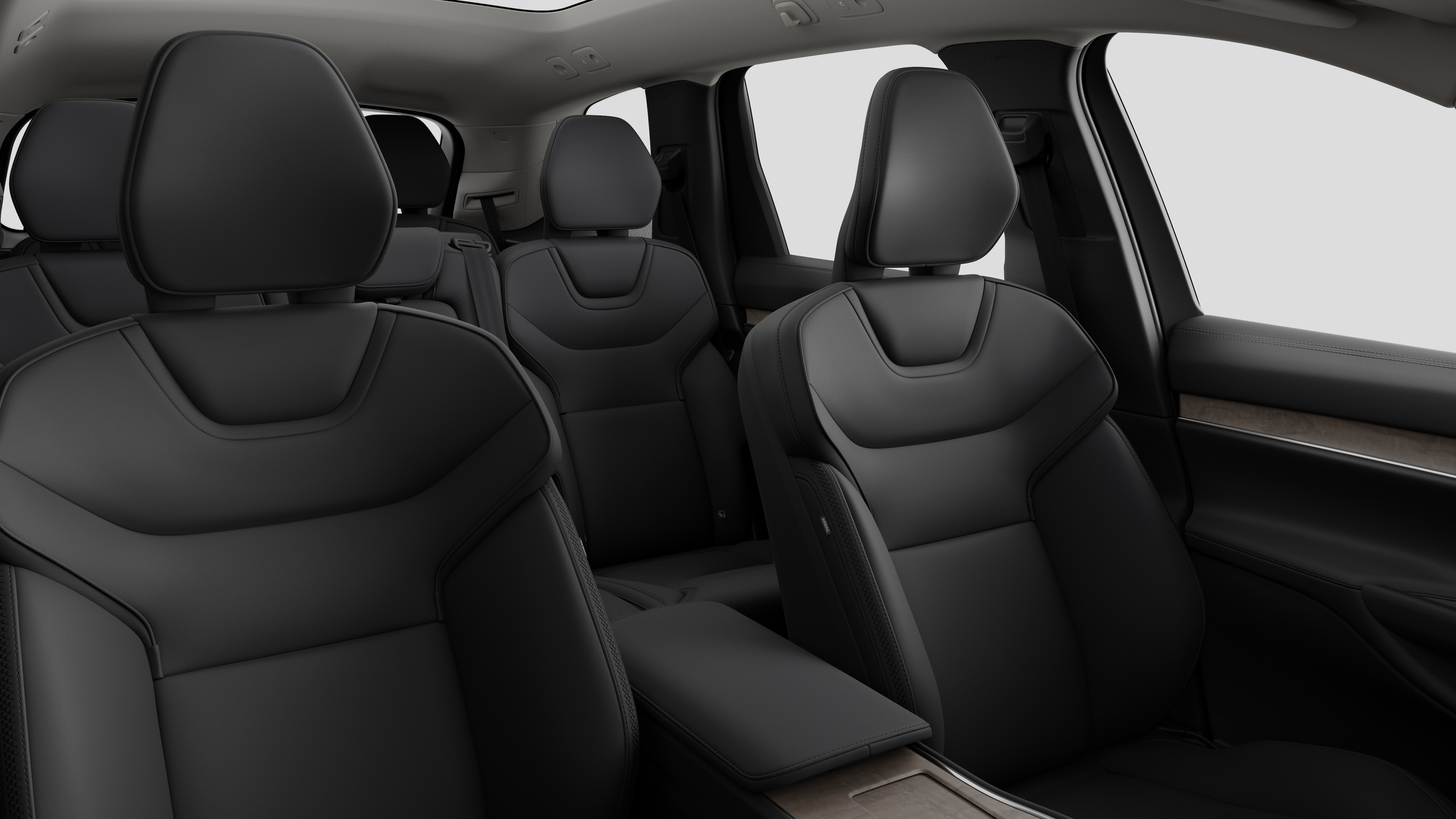 Volvo car interior showing rear passenger seats and center console in plain studio background.
