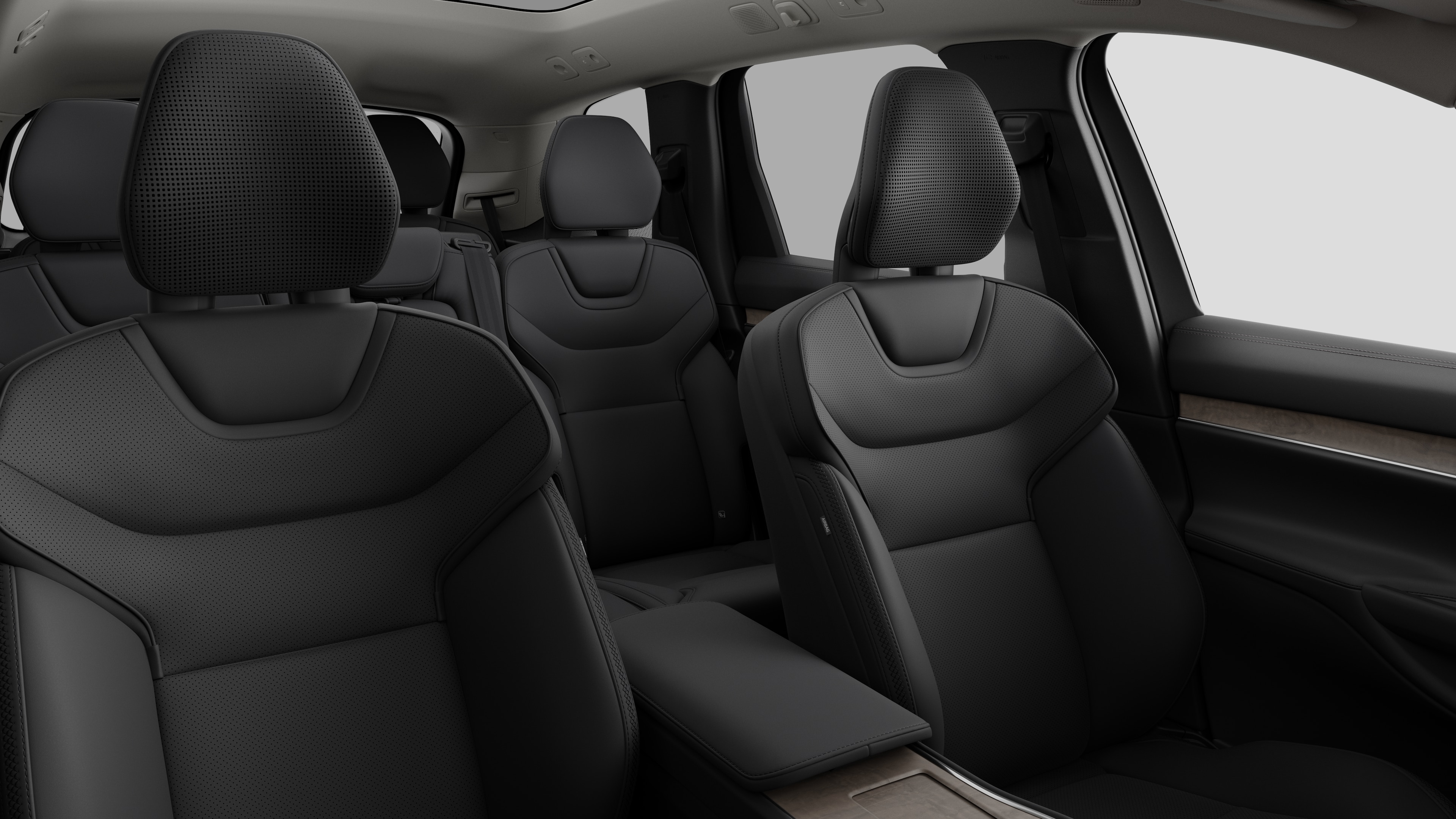 Volvo car interior showing rear passenger seats and center console in plain studio background.