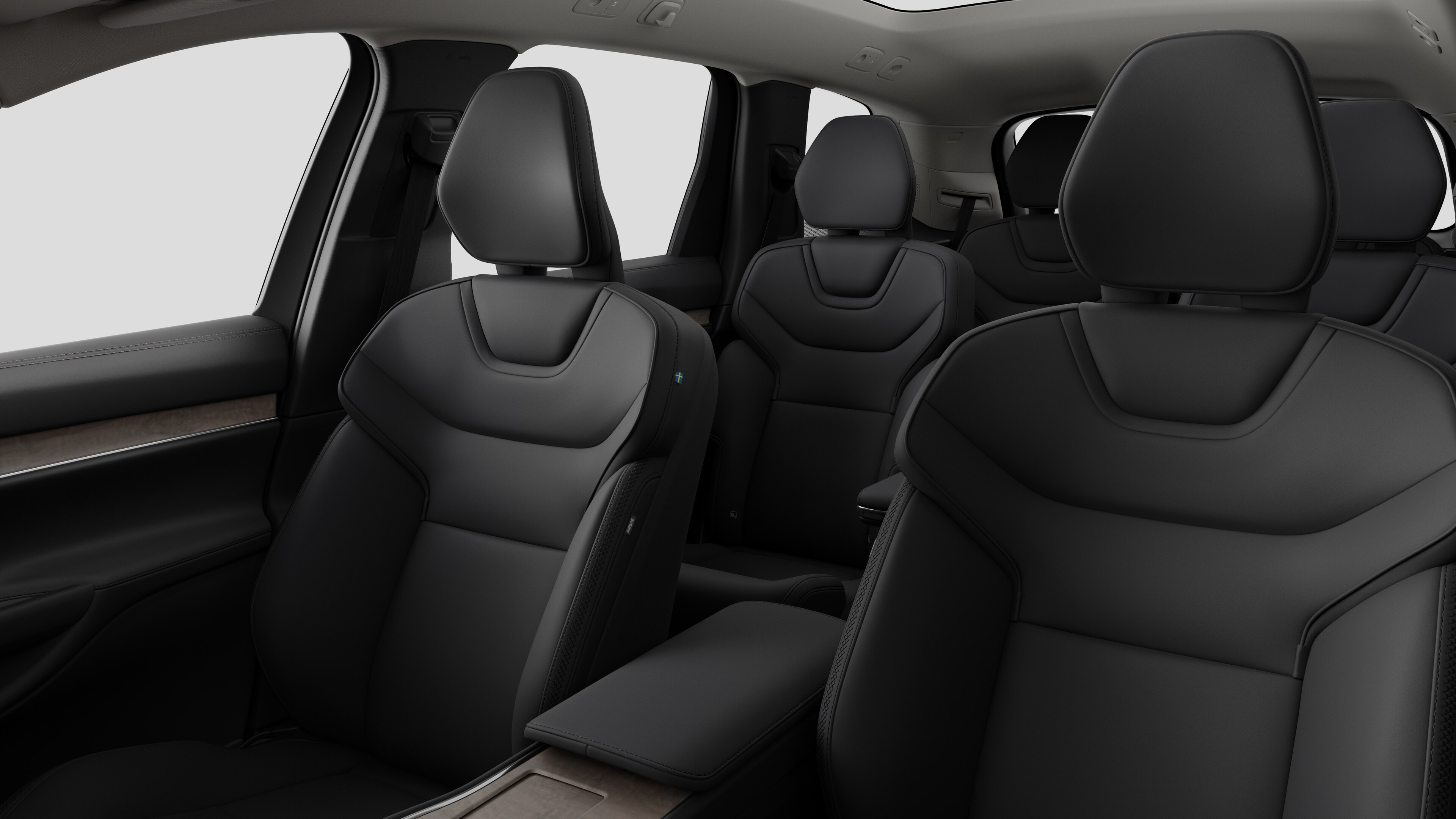 Volvointeriör som visar bakre passagerarsäten och mittkonsol i en vanlig studiobakgrund.