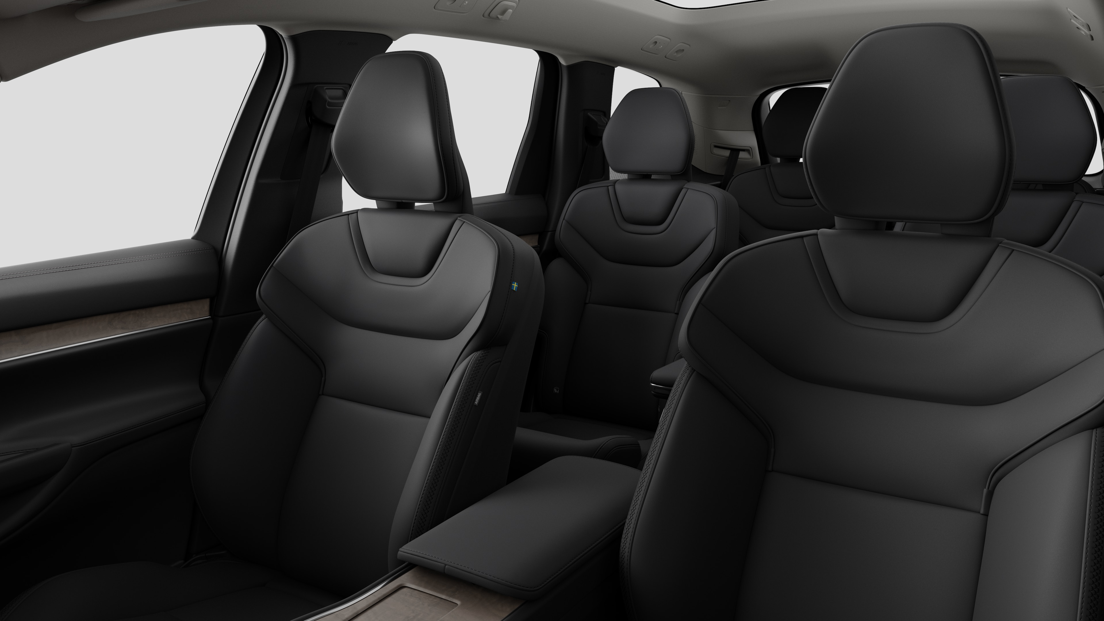 Interiør i en Volvo med bakseter og midtkonsoll i vanlig studiobakgrunn.