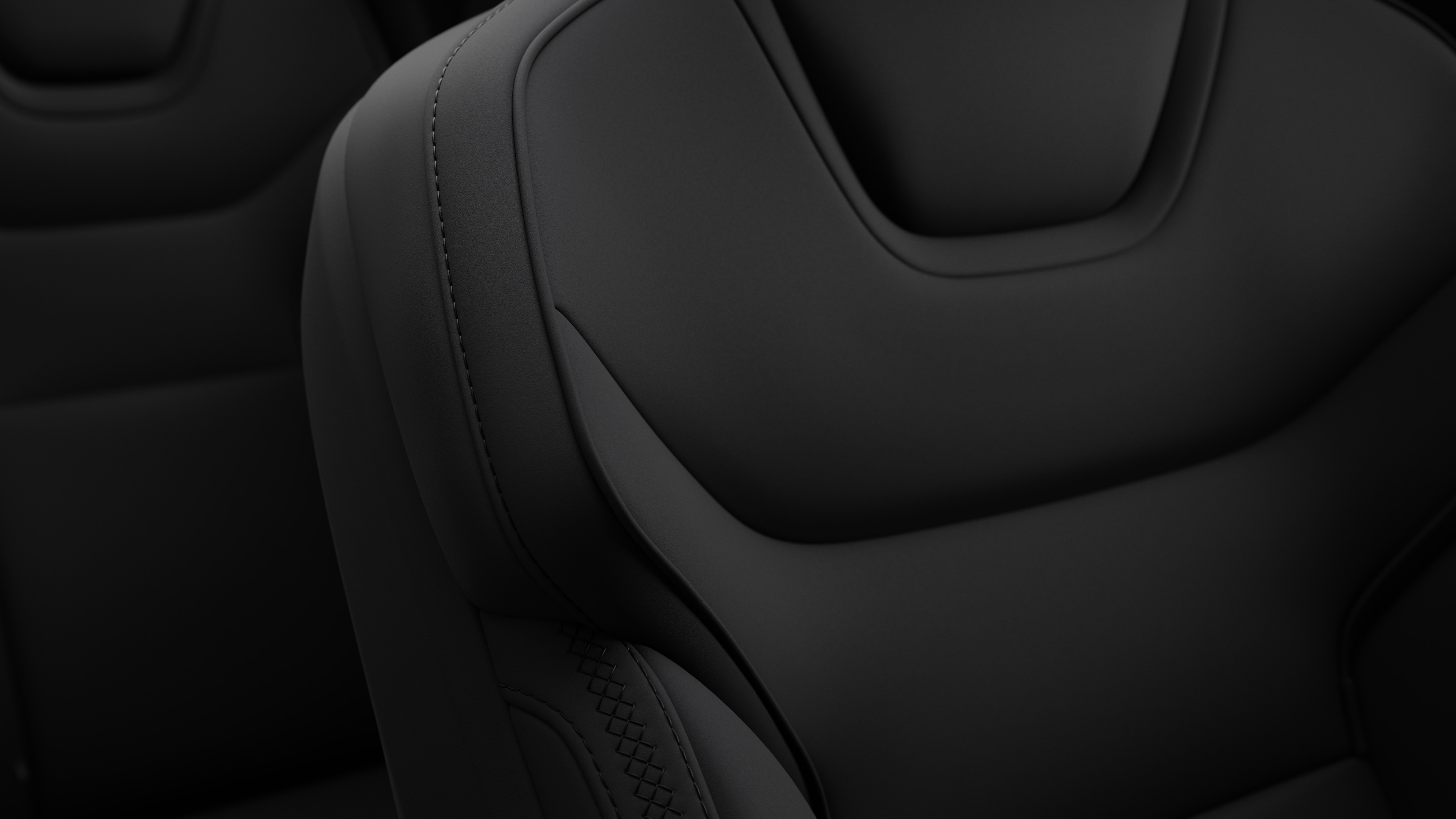 Close-up of Volvo car interior seat detail showing stitching and a small Swedish flag tag.