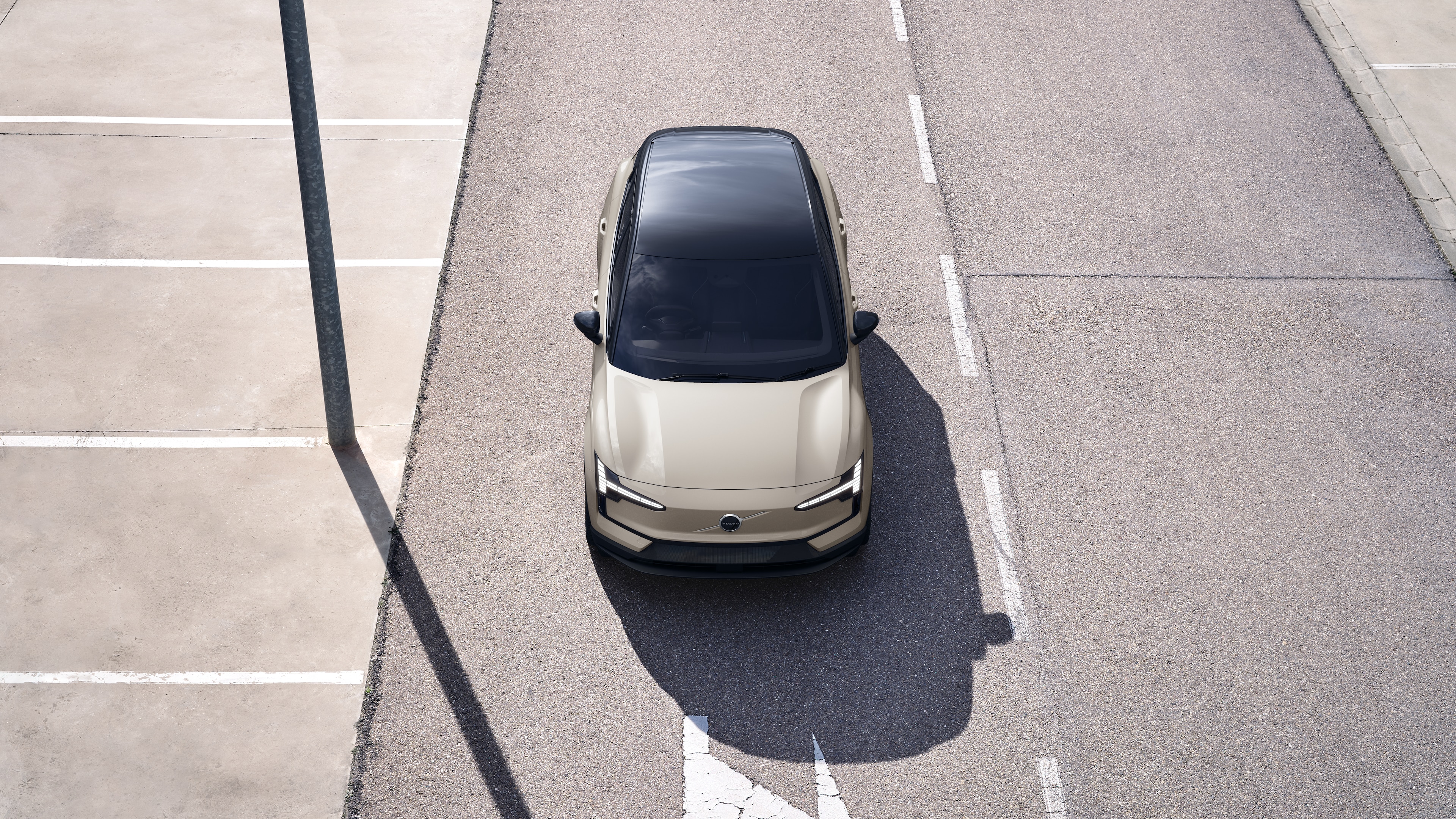 Volvo car exterior in three-quarter view on an urban street background, showing one side, roof, and part of the front.