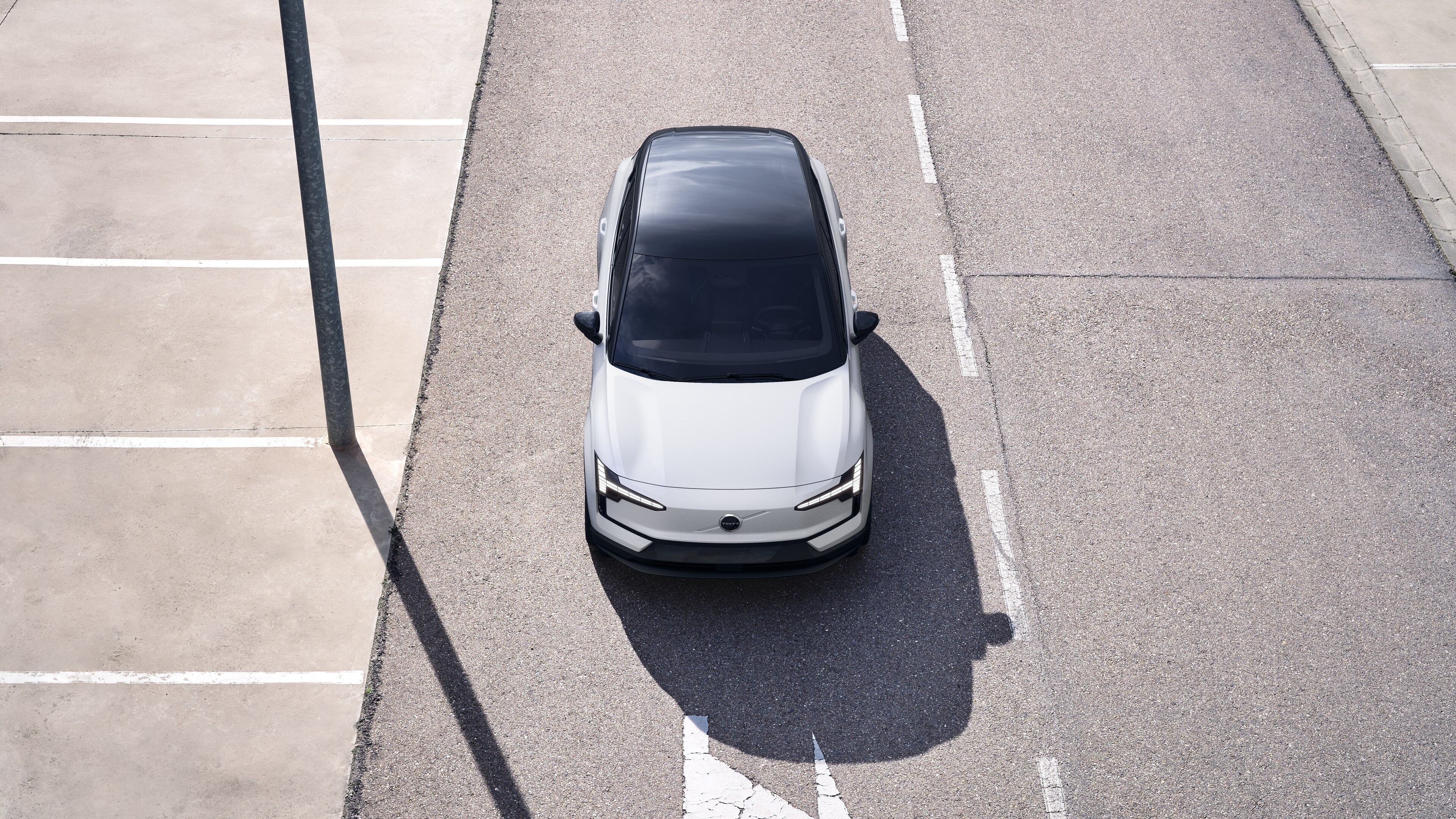 Volvo car exterior in three-quarter view on an urban street background, showing one side, roof, and part of the front.