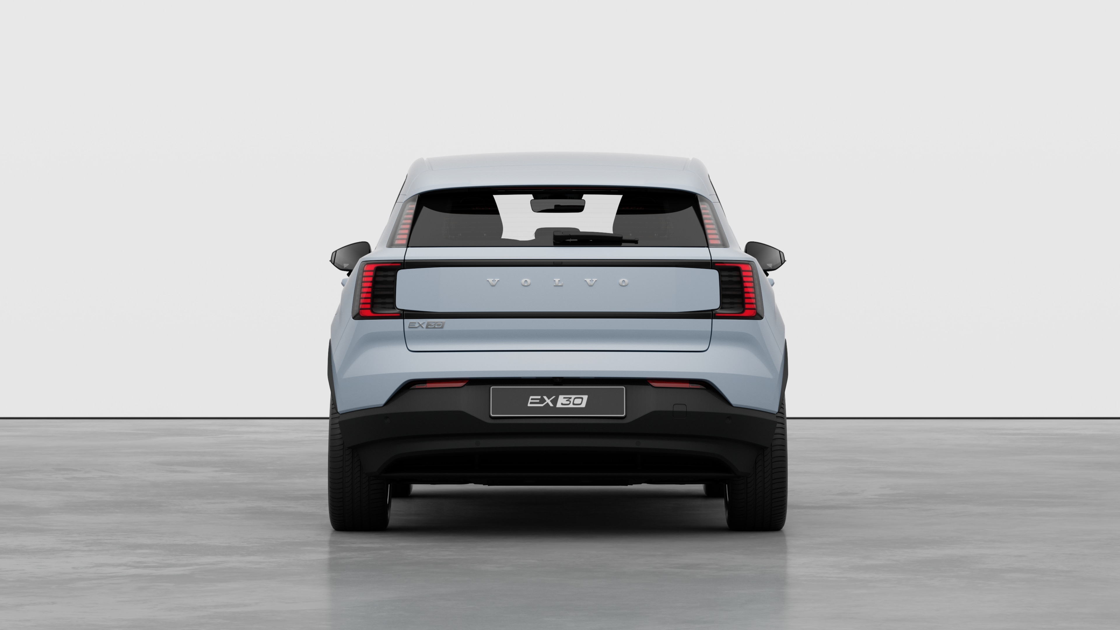 Vista traseira do automóvel Volvo contra um fundo de estúdio simples.