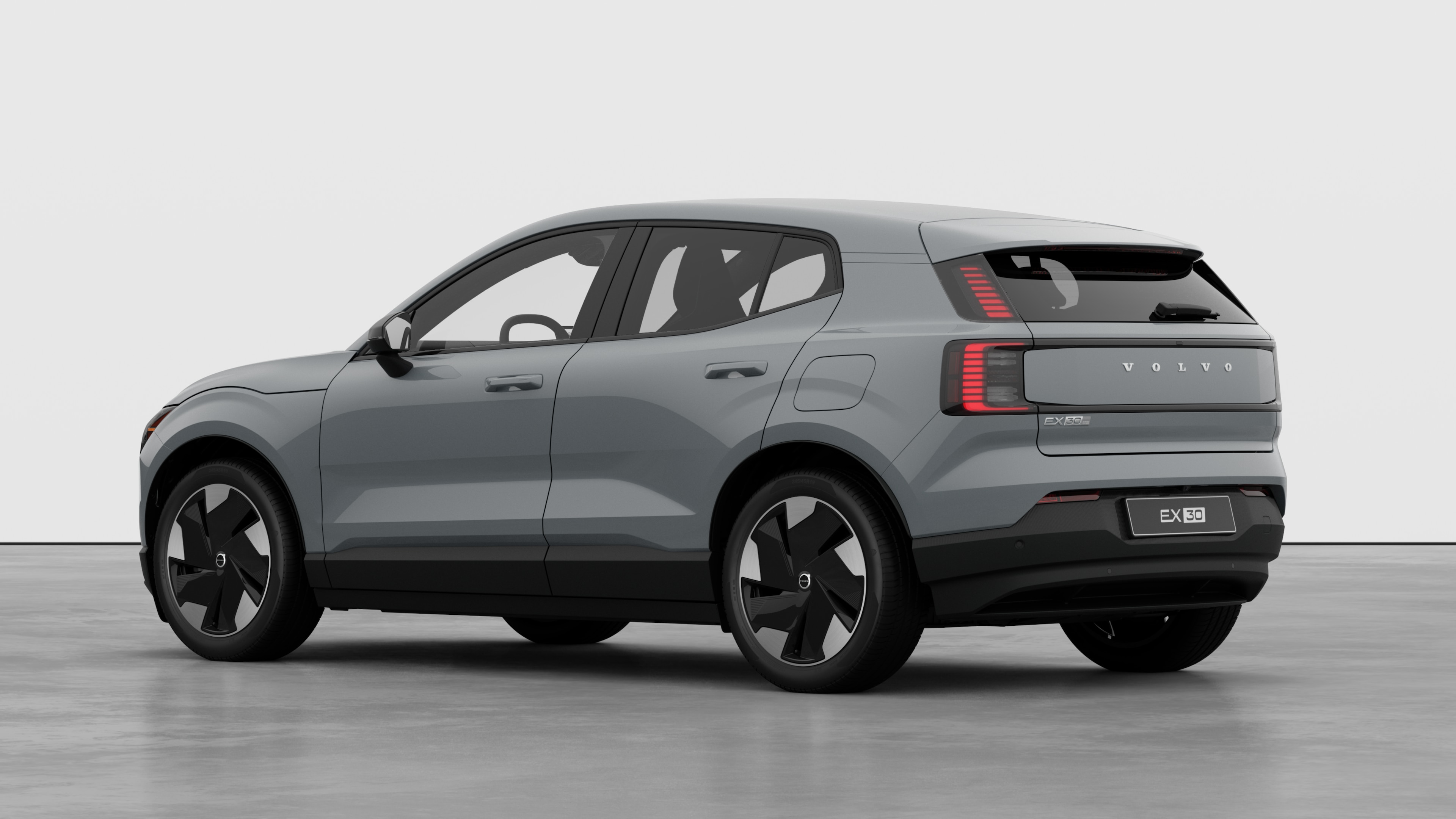 Volvo car rear three-quarter view in a plain studio background.