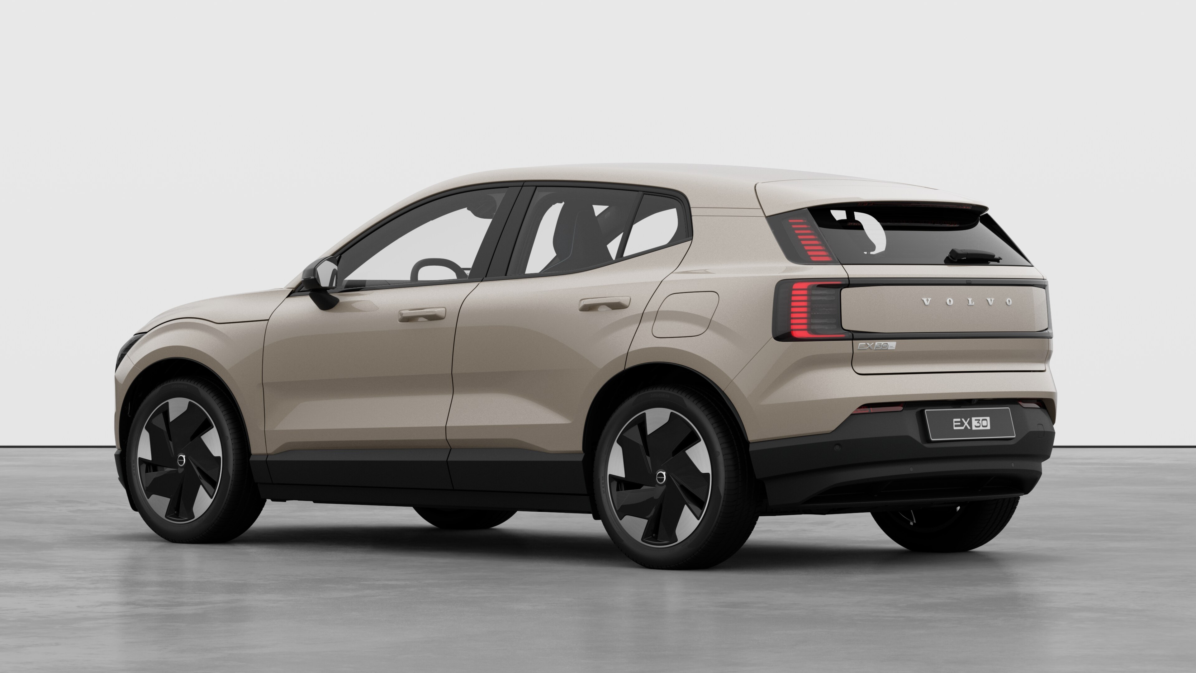 Volvo car rear three-quarter view in a plain studio background.