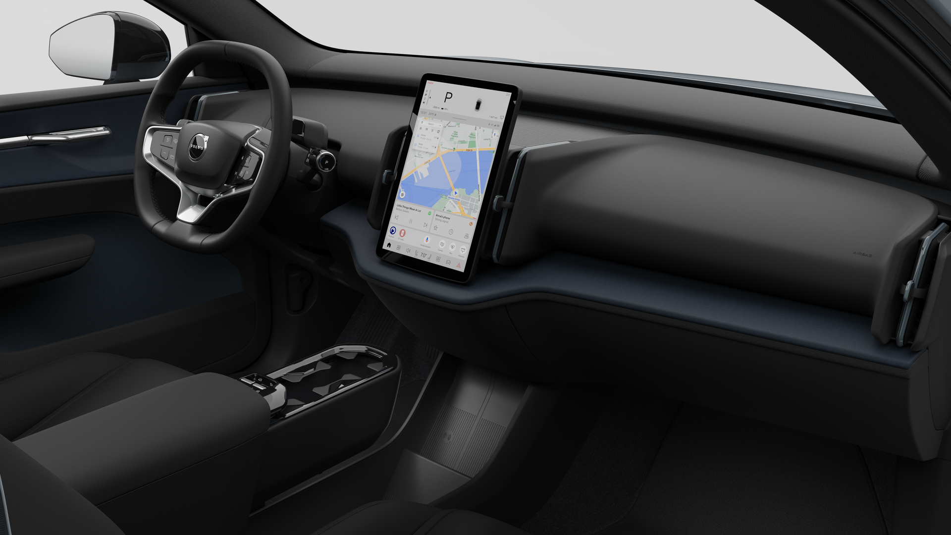 Vista interior de un vehículo Volvo que muestra el salpicadero, el volante, la consola central y la pantalla de visualización digital en un fondo de estudio liso.