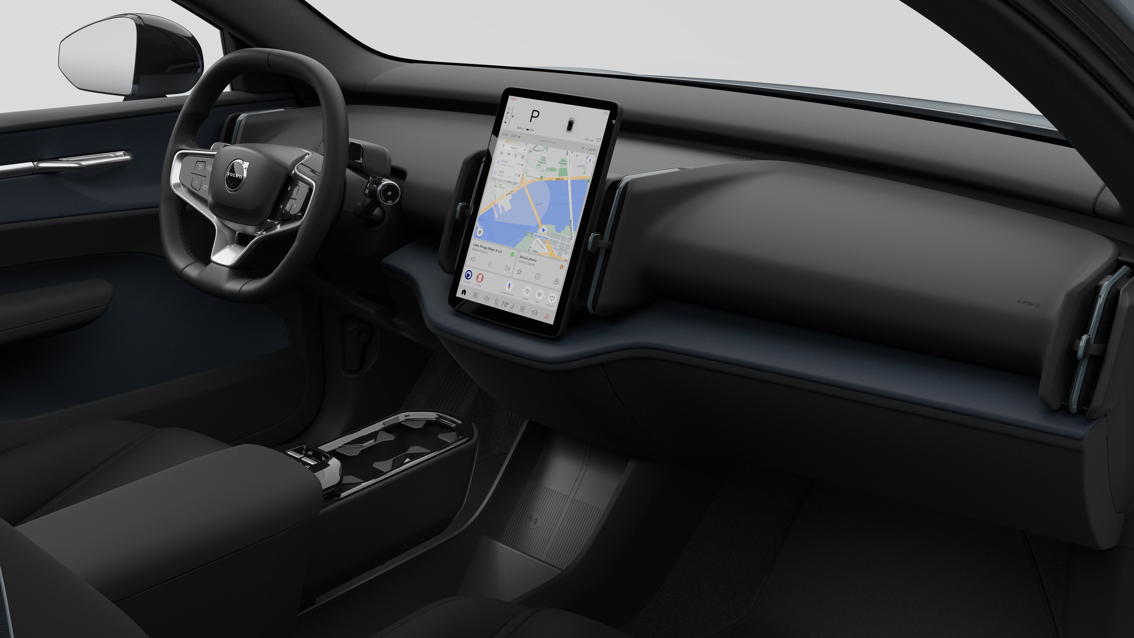 Vista interior de un vehículo Volvo que muestra el salpicadero, el volante, la consola central y la pantalla de visualización digital en un fondo de estudio liso.