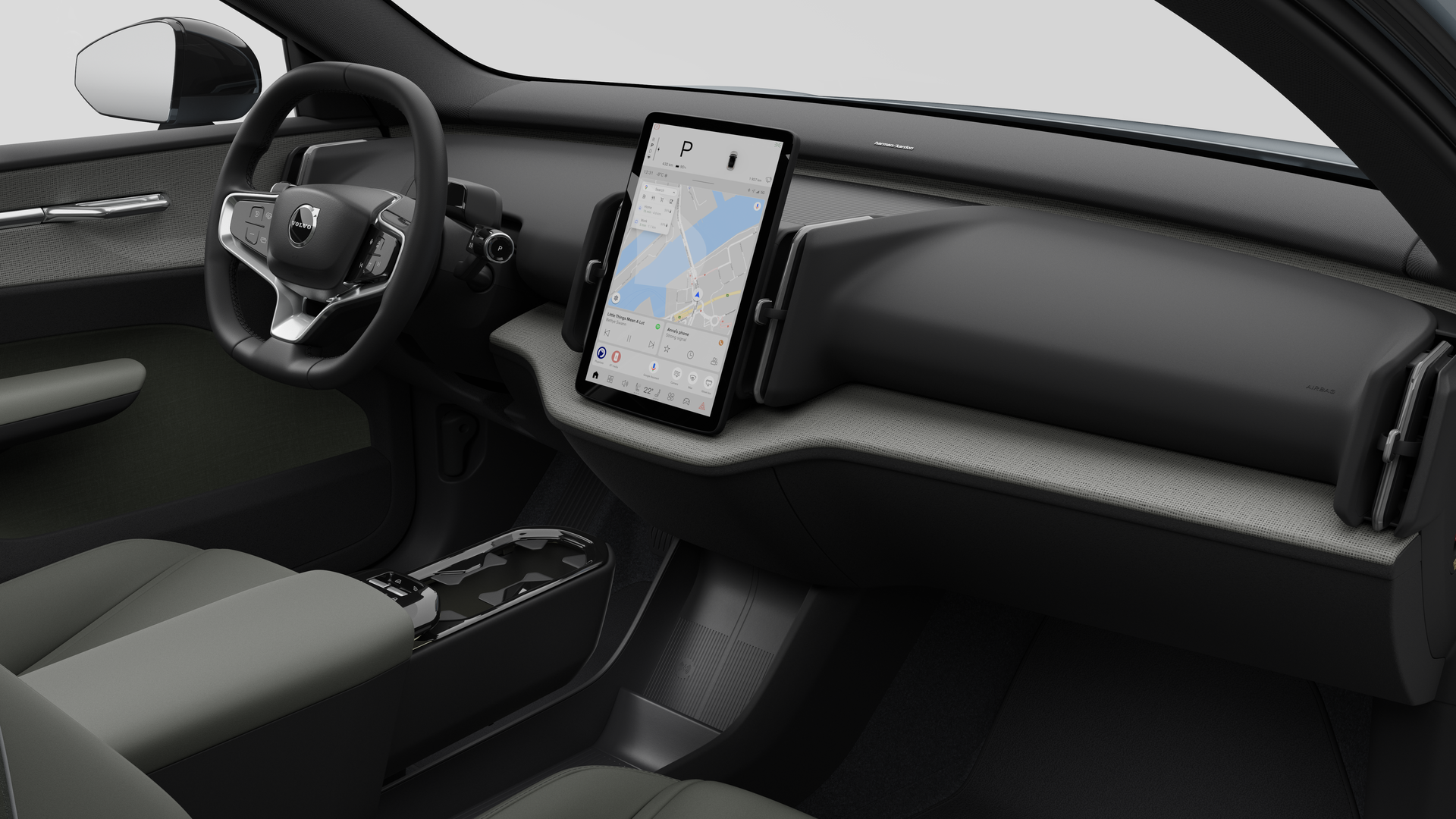Volvo 汽車的內部視圖，以純色工作室背景顯示儀錶板、方向盤、中控台和數字顯示幕。