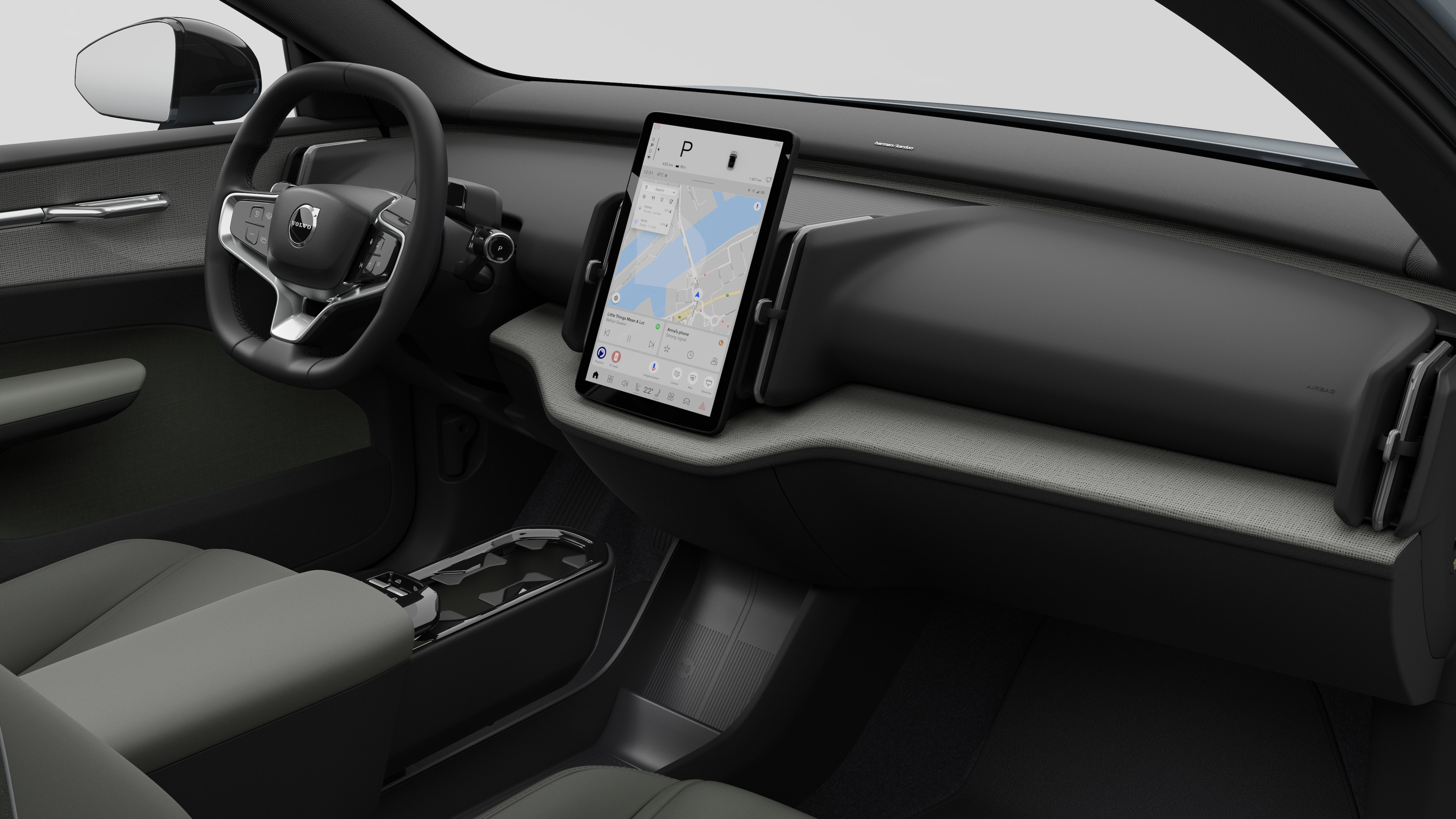 Volvo 汽車的內部視圖，以純色工作室背景顯示儀錶板、方向盤、中控台和數字顯示幕。