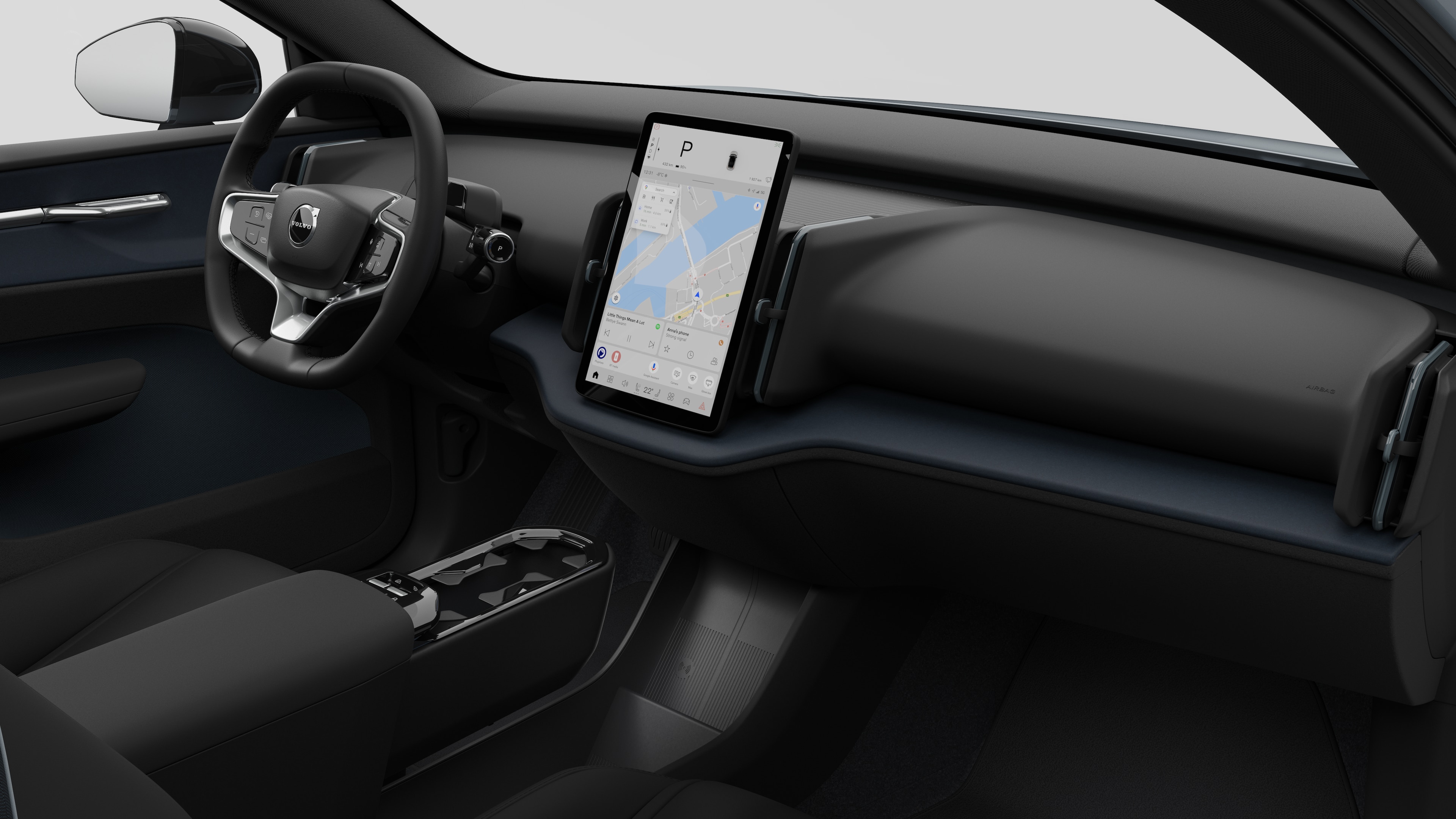 "Volvo" automobilio salono vaizdas, kuriame rodomas prietaisų skydelis, vairas, centrinė konsolė ir skaitmeninis ekranas paprastame studijos fone.