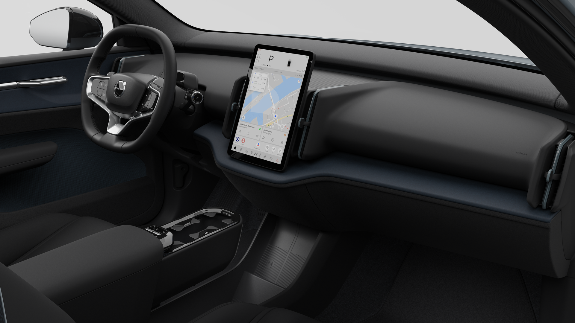 Pamja e brendshme e një makine Volvo që tregon pultin, timonin, konsolën qendrore dhe ekranin e ekranit dixhital në një sfond të thjeshtë studioje.