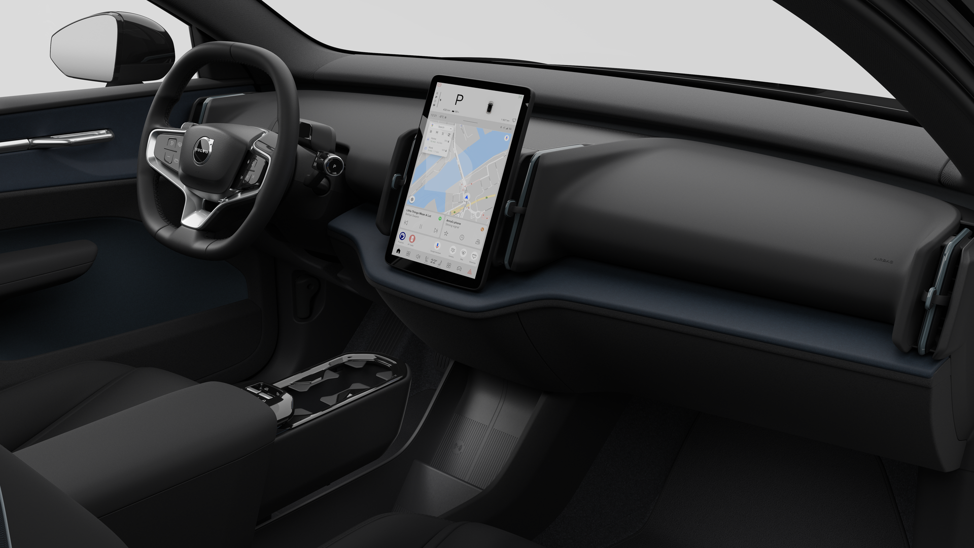 Vue intérieure d’une Volvo montrant le tableau de bord, le volant, la console centrale et l’écran d’affichage numérique sur un fond de studio uni.