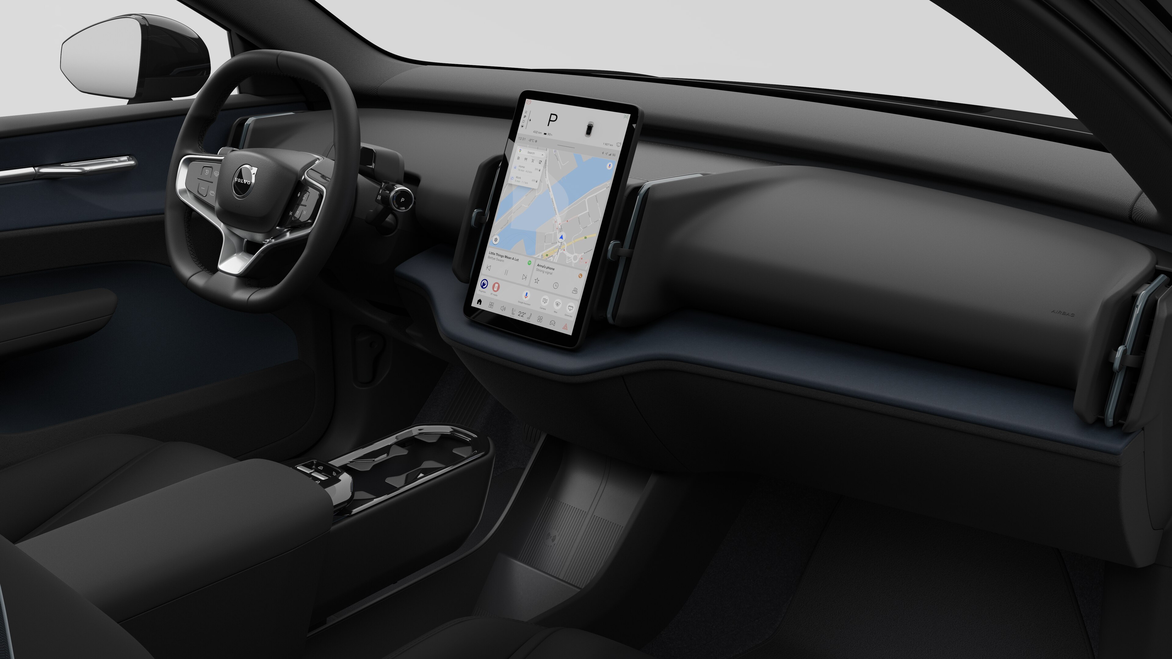 Binnenaanzicht van een Volvo met het dashboard, stuur, middenconsole en digitale display op een effen studioachtergrond.