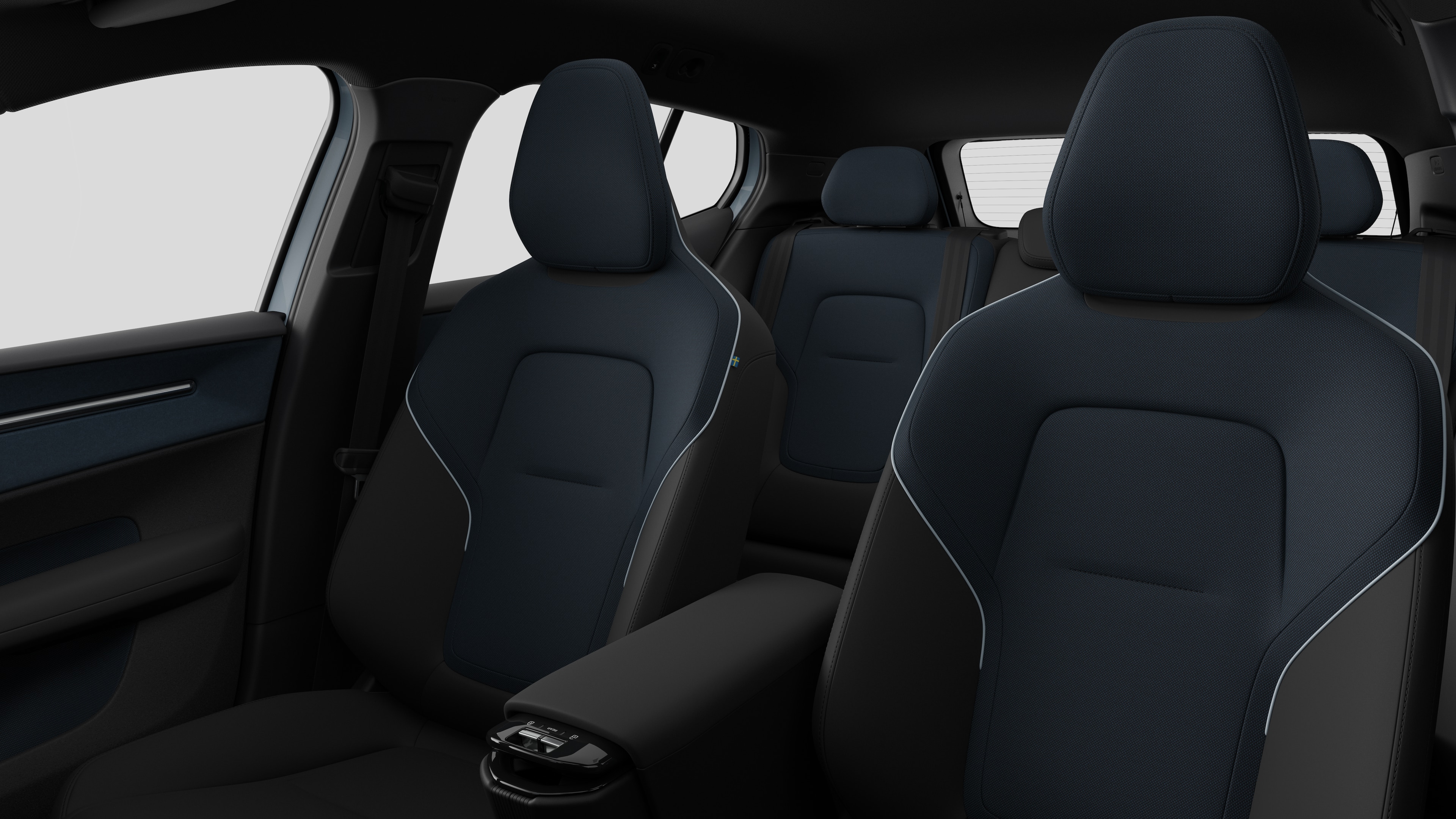 Intérieur d’une Volvo montrant les sièges passager arrière et la console centrale en arrière-plan de studio.