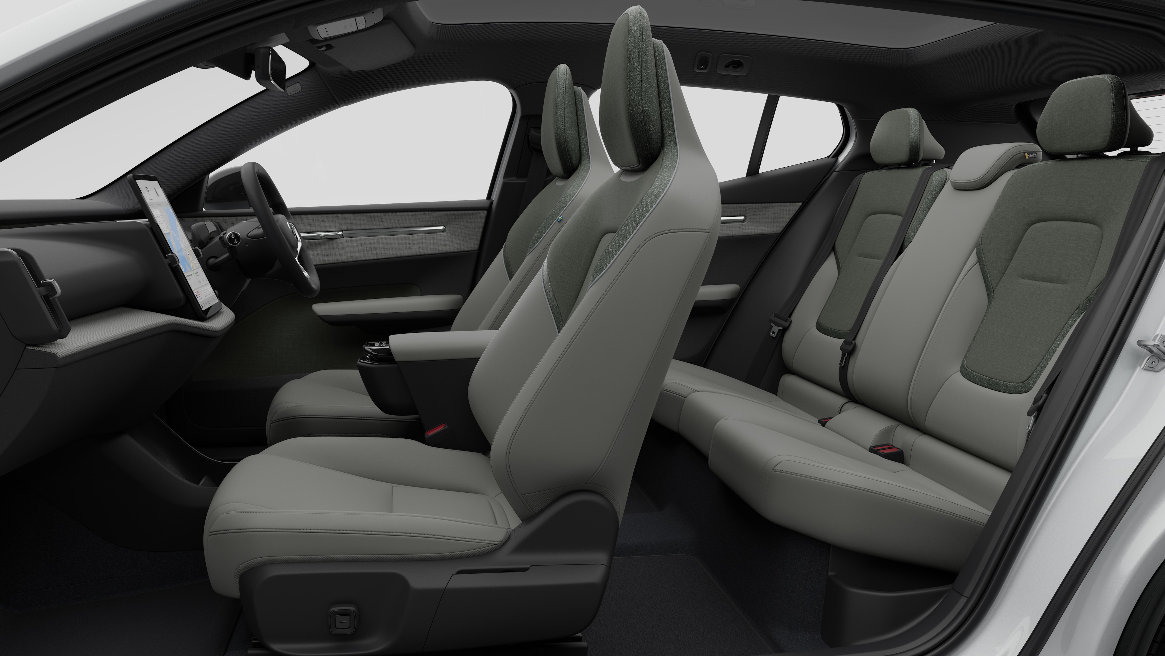 Volvo car interior side view showcasing front seats, rear passenger seats, steering wheel, dashboard, and center console, set against plain studio background.