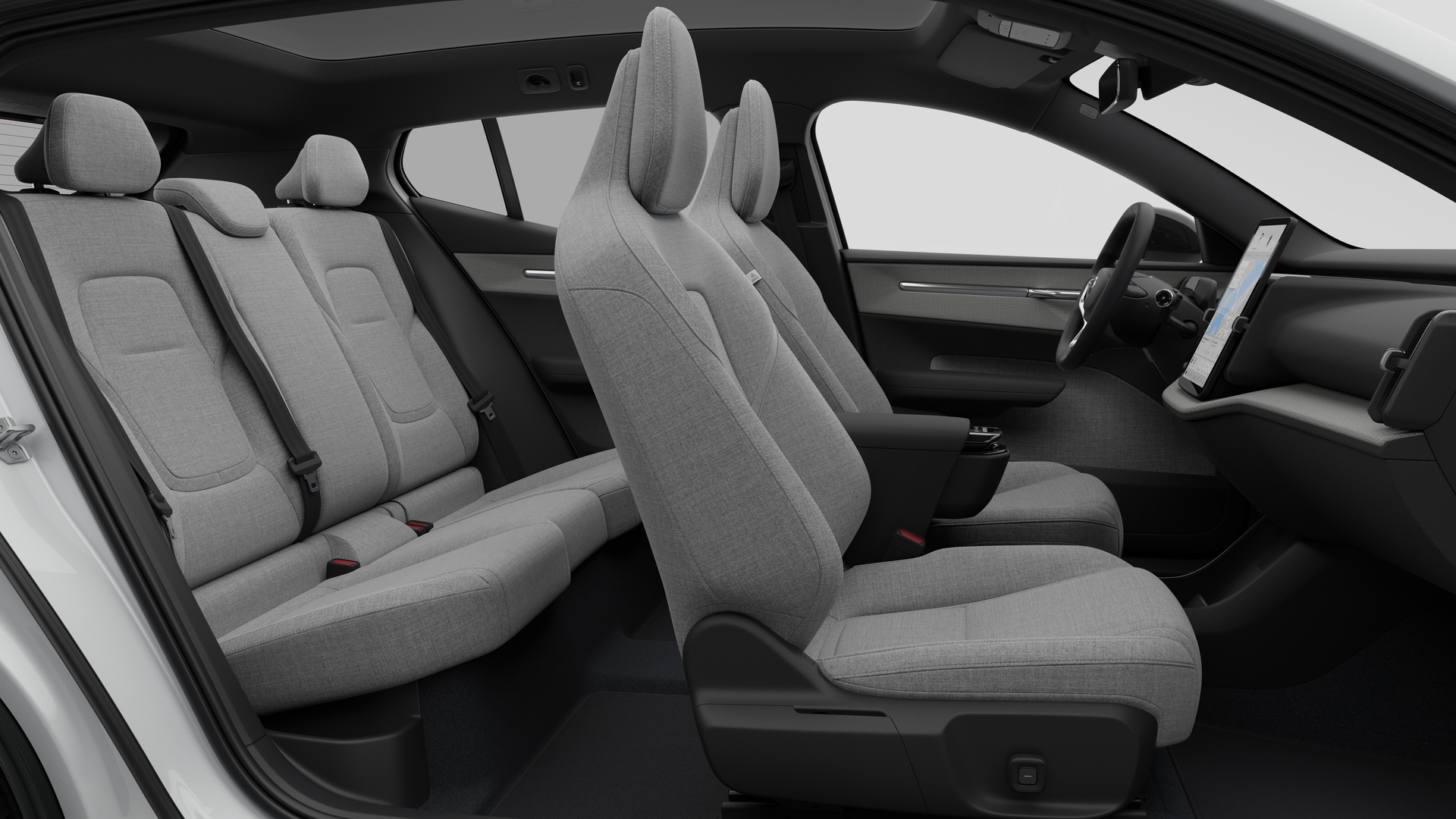 Vue latérale de l’intérieur d’une Volvo montrant les sièges avant, les sièges passager arrière, le volant, le tableau de bord et la console centrale, sur fond de studio.