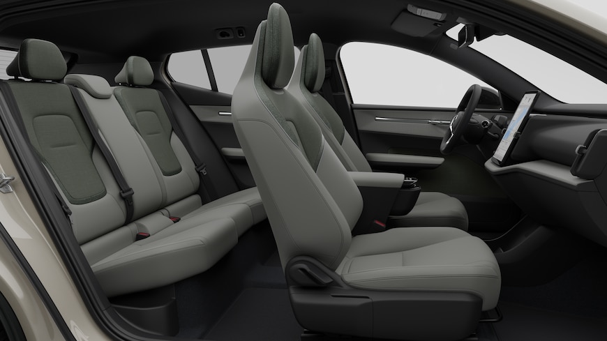 Volvos innvendige sidevisning med forseter, bakseter, ratt, dashbord og midtkonsoll, satt mot vanlig studiobakgrunn.