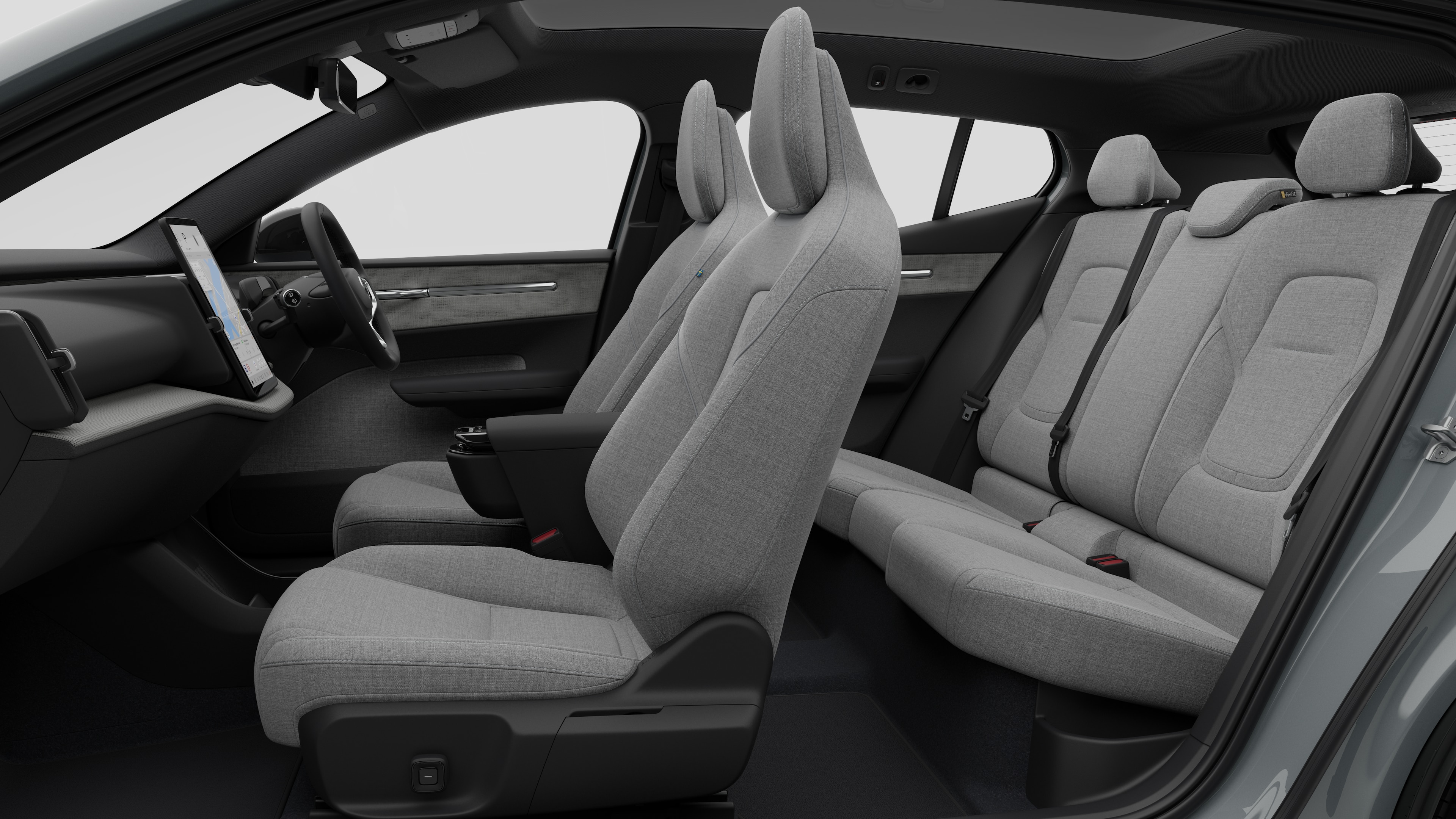 Volvo car interior side view showcasing front seats, rear passenger seats, steering wheel, dashboard, and center console, set against plain studio background.
