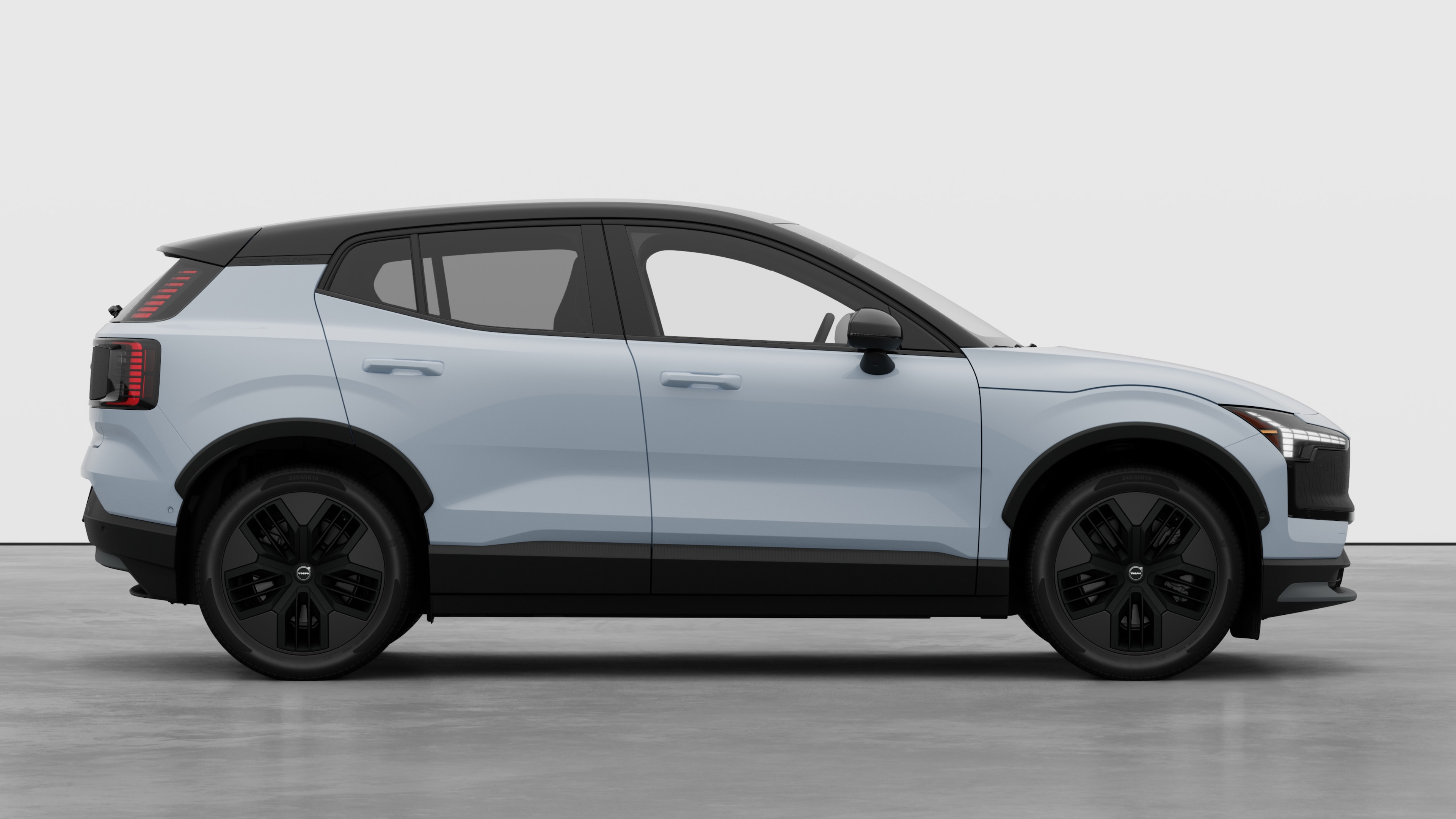 Volvo car side view on plain studio background displaying closed doors and visible wheel design.