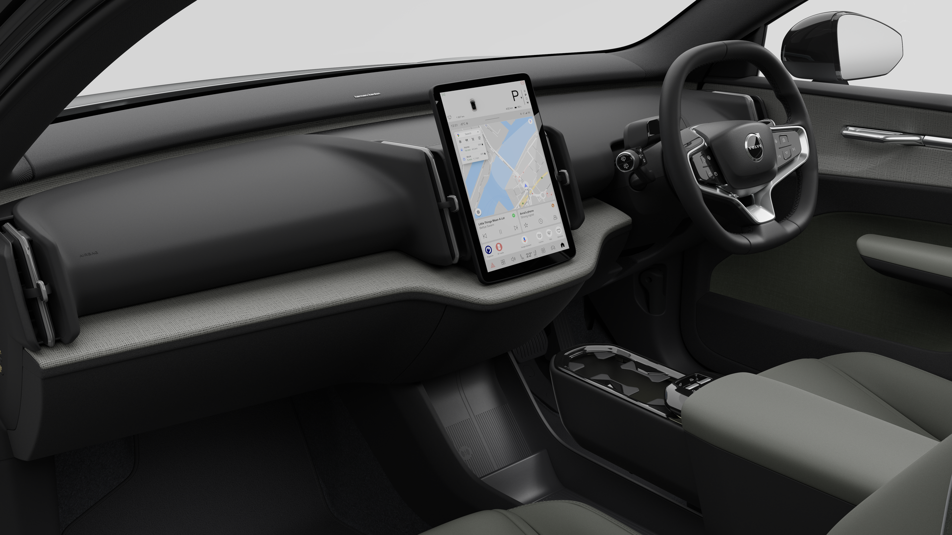簡素なスタジオ背景にダッシュボード、ステアリングホイール、センターコンソール、デジタルディスプレイ画面を映し出すボルボ車のインテリア画像。