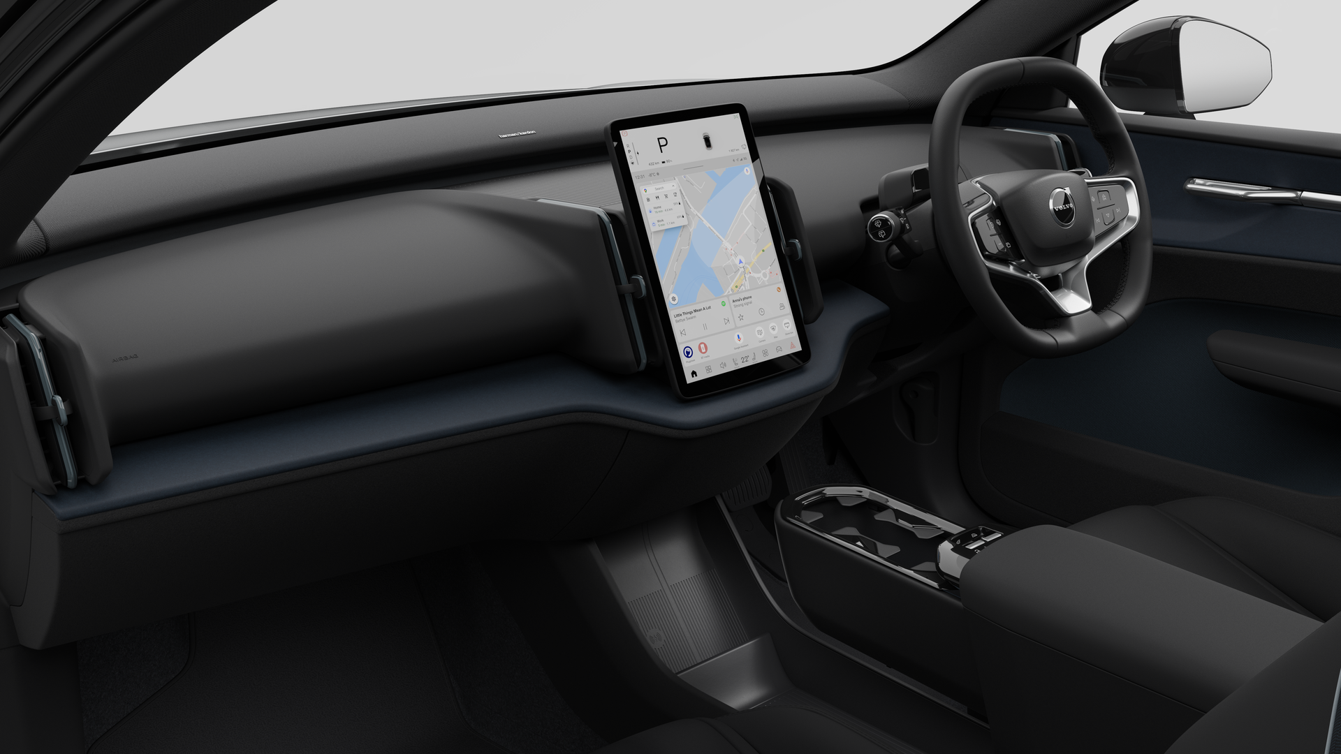 Interior view of a Volvo car showing the dashboard, steering wheel, center console, and digital display screen in a plain studio background.