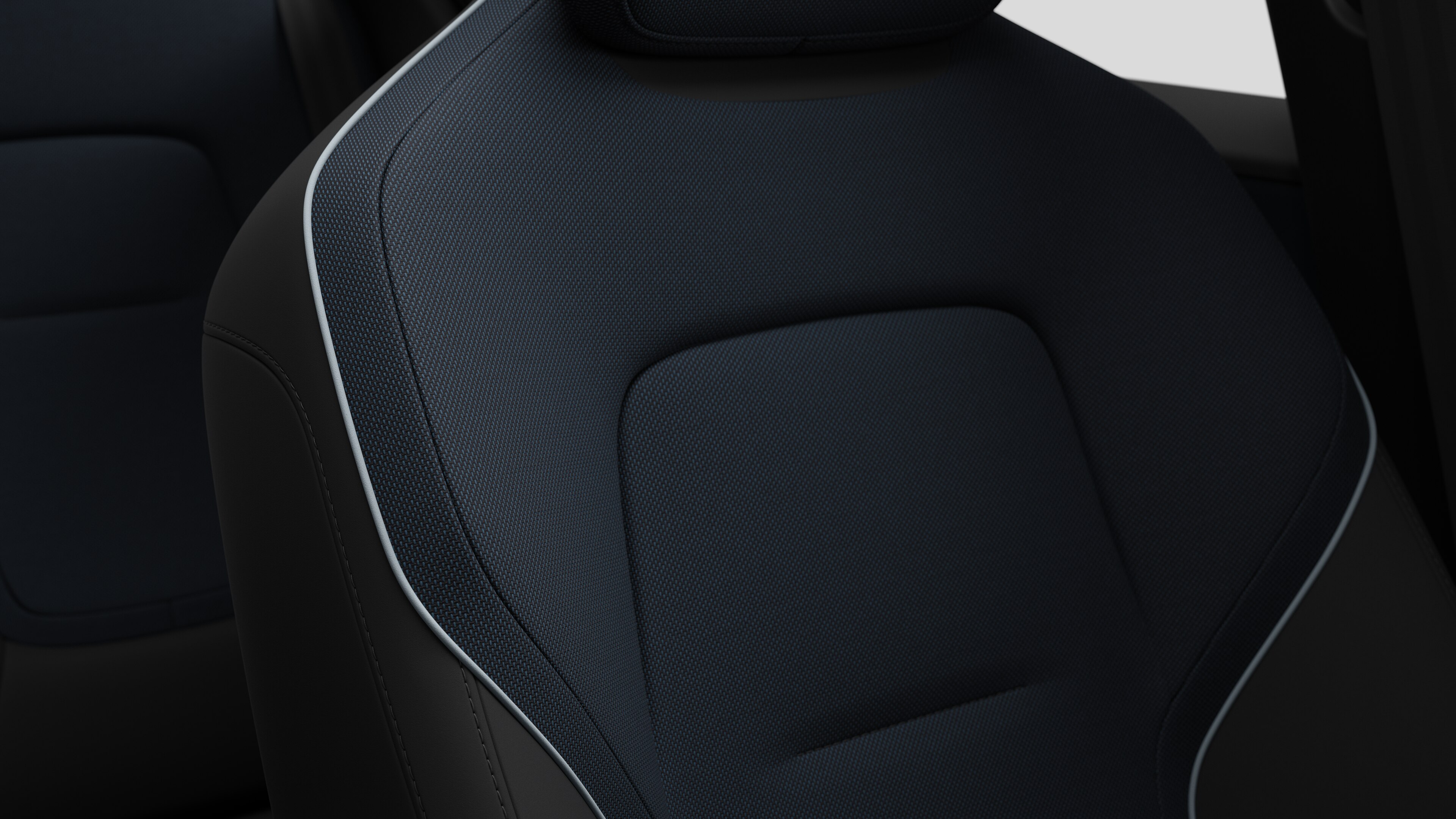 Close-up of Volvo car interior seat detail showing stitching and a small Swedish flag tag.