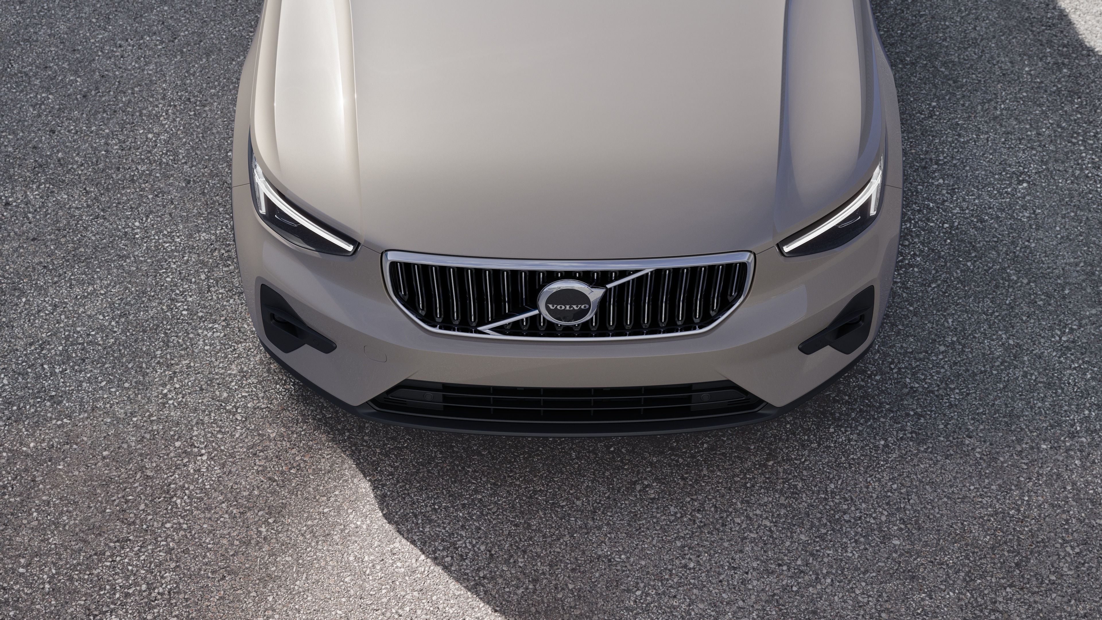 Volvo car exterior in three-quarter view on an urban street background, showing one side, roof, and part of the front.