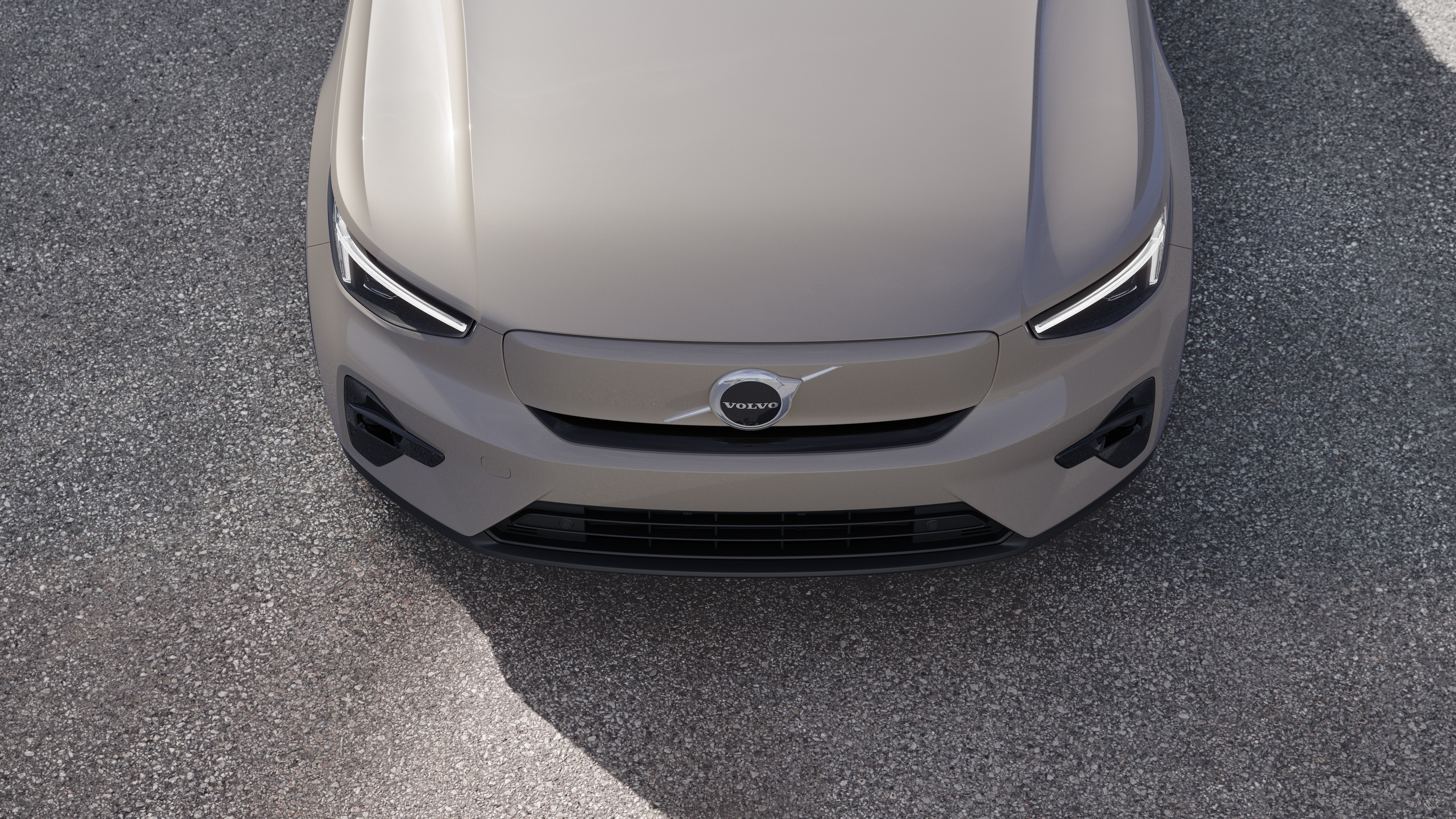 Volvo car exterior in three-quarter view on an urban street background, showing one side, roof, and part of the front.