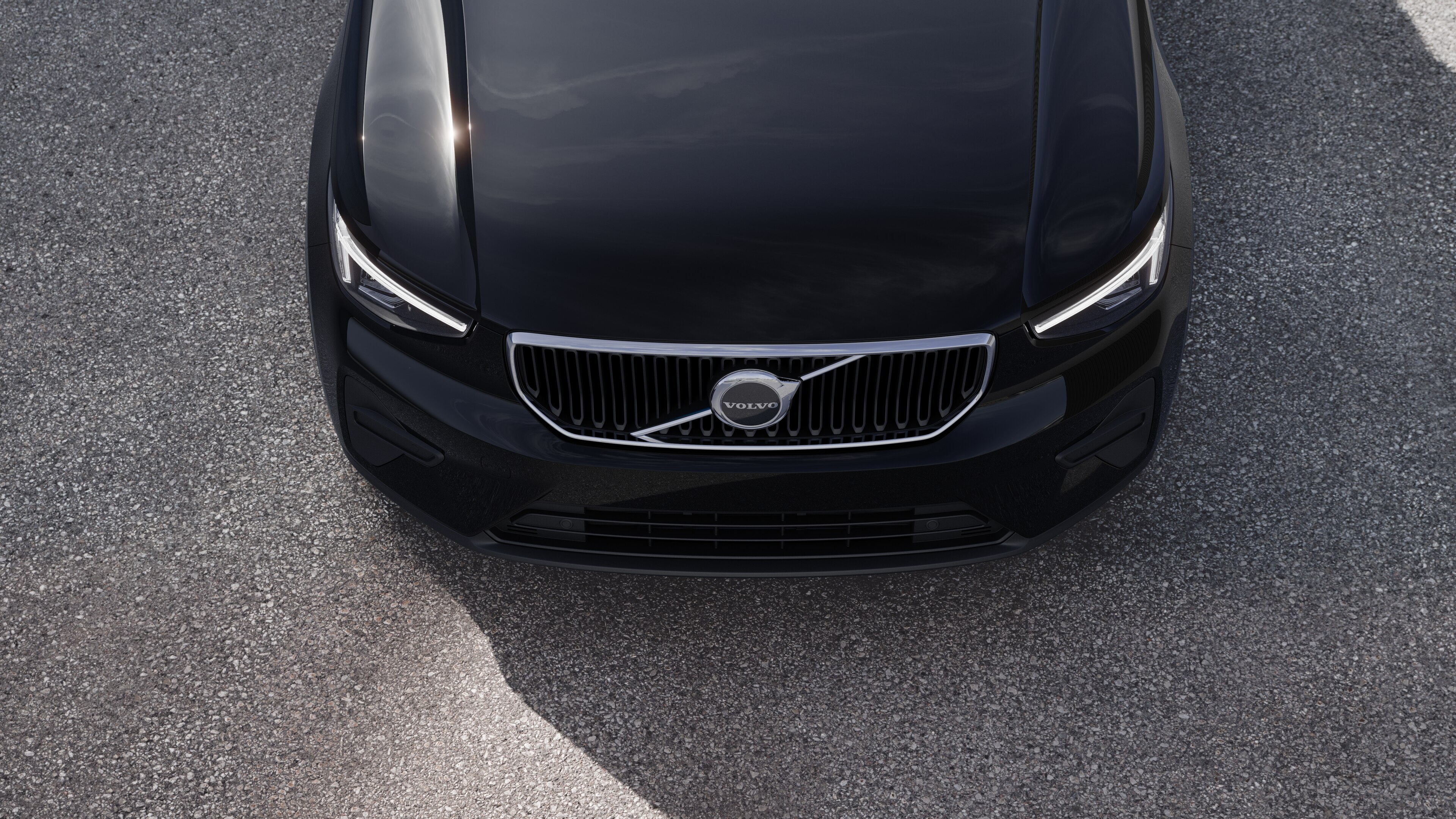 Volvo car exterior in three-quarter view on an urban street background, showing one side, roof, and part of the front.