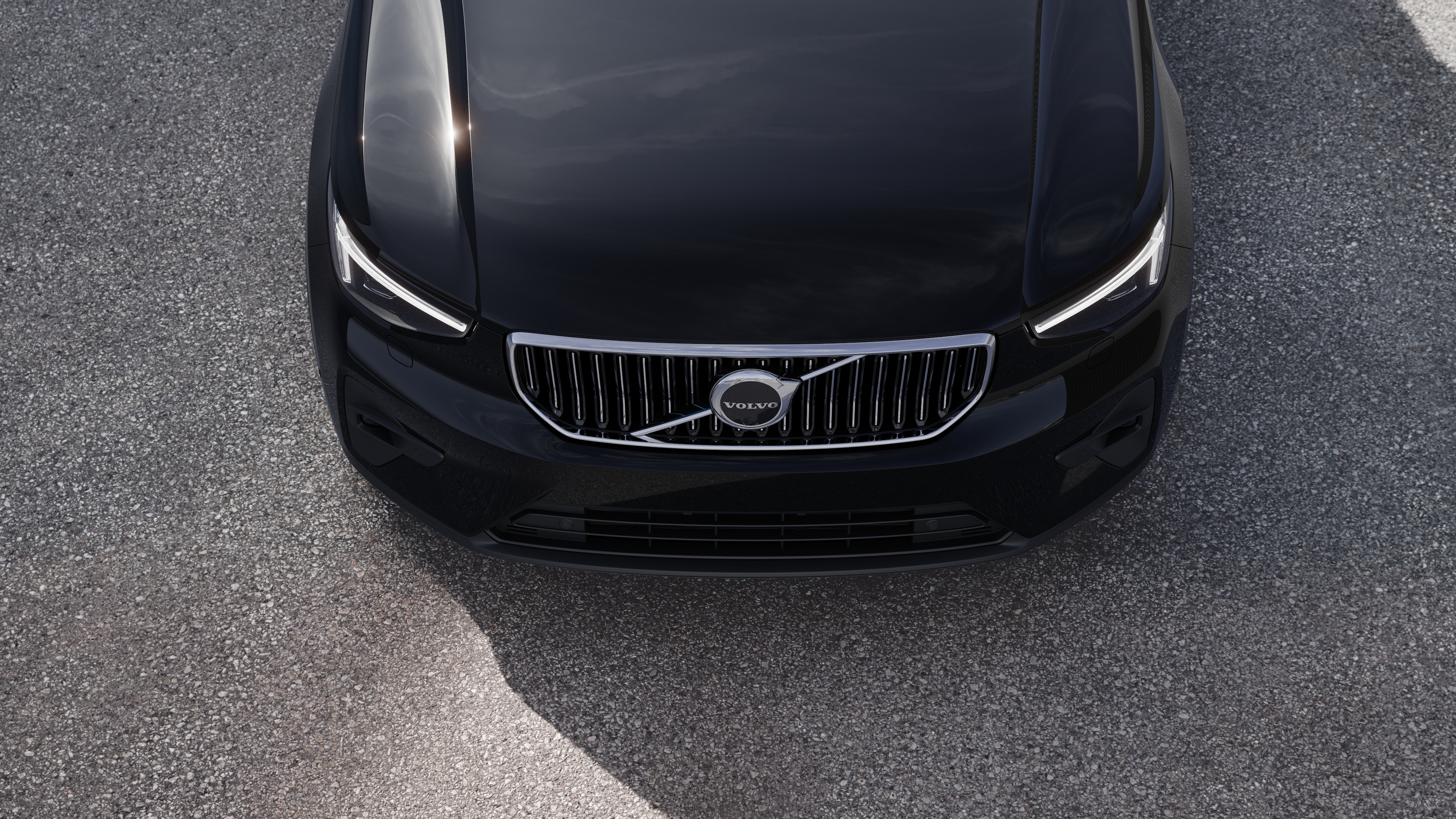 Volvo car exterior in three-quarter view on an urban street background, showing one side, roof, and part of the front.