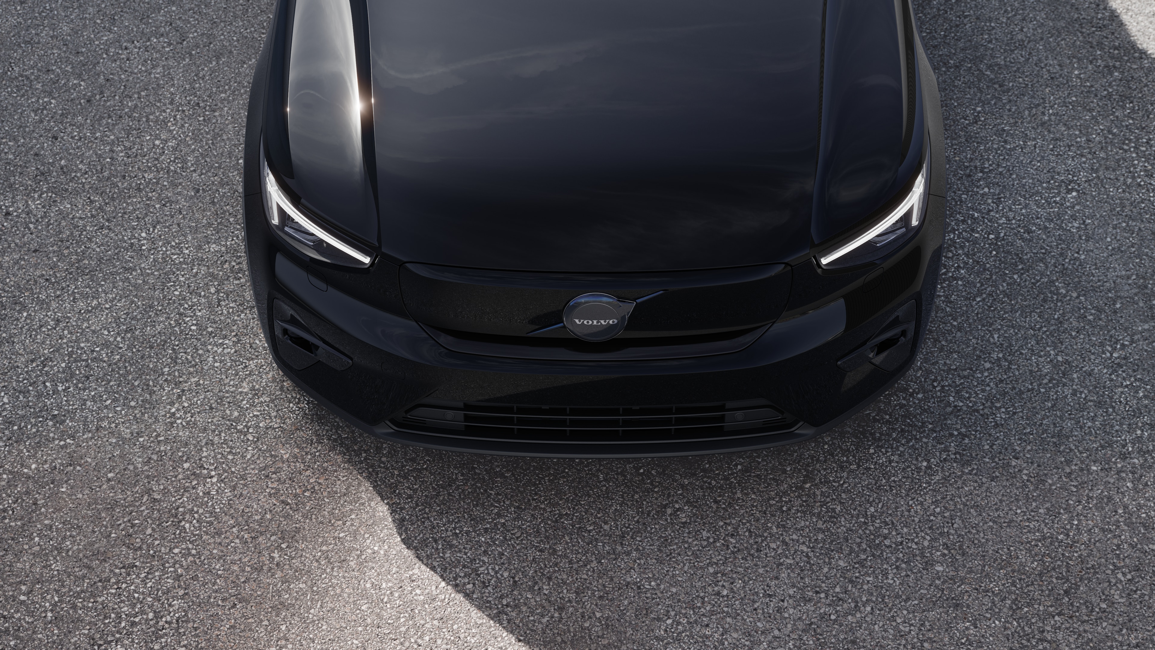 Volvo-auton ulkopuoli kolmen neljäsosan näkymässä kaupunkien katutaustalla, toinen puoli, katto ja osa edestä.