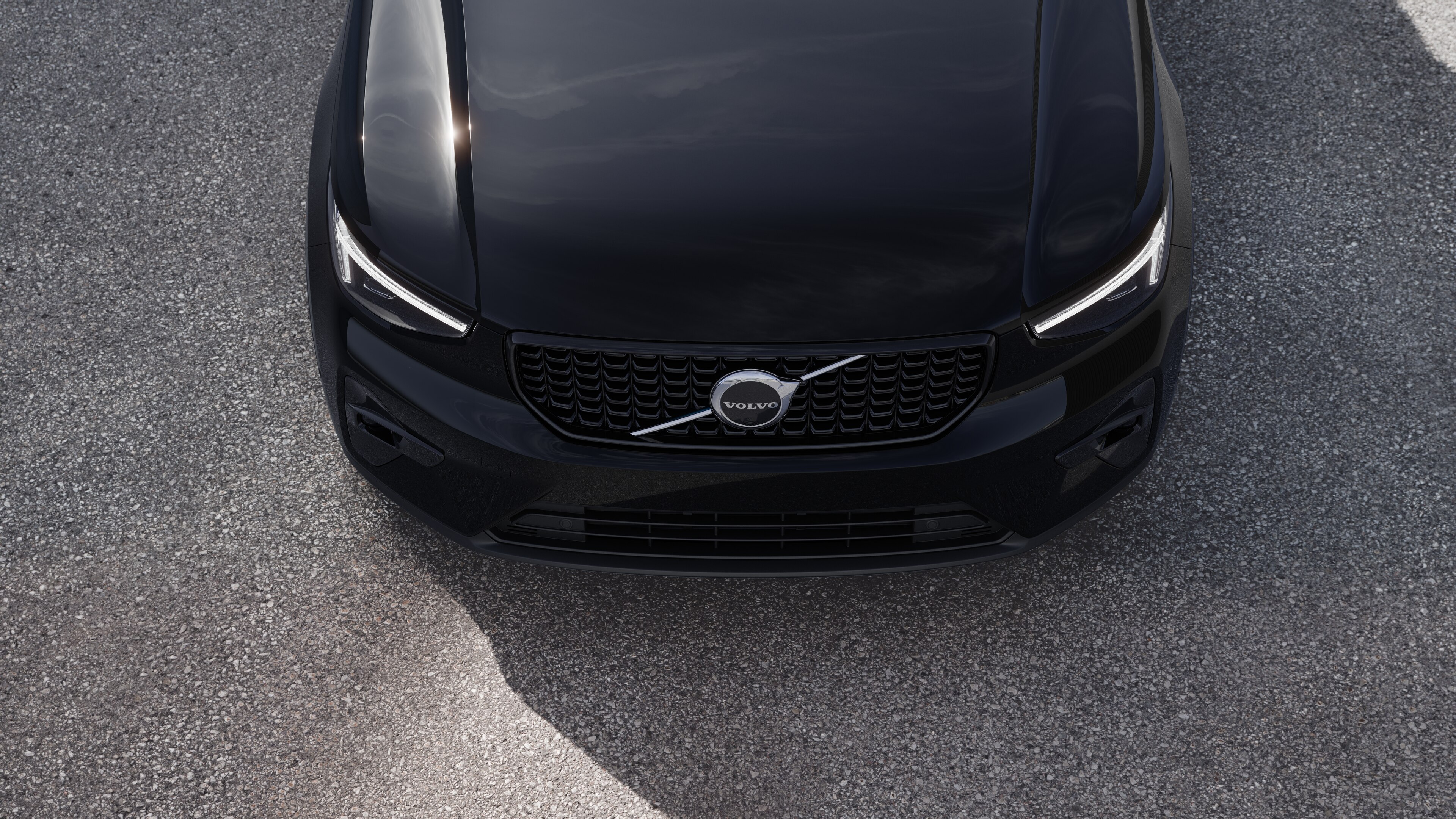 Volvo car exterior in three-quarter view on an urban street background, showing one side, roof, and part of the front.