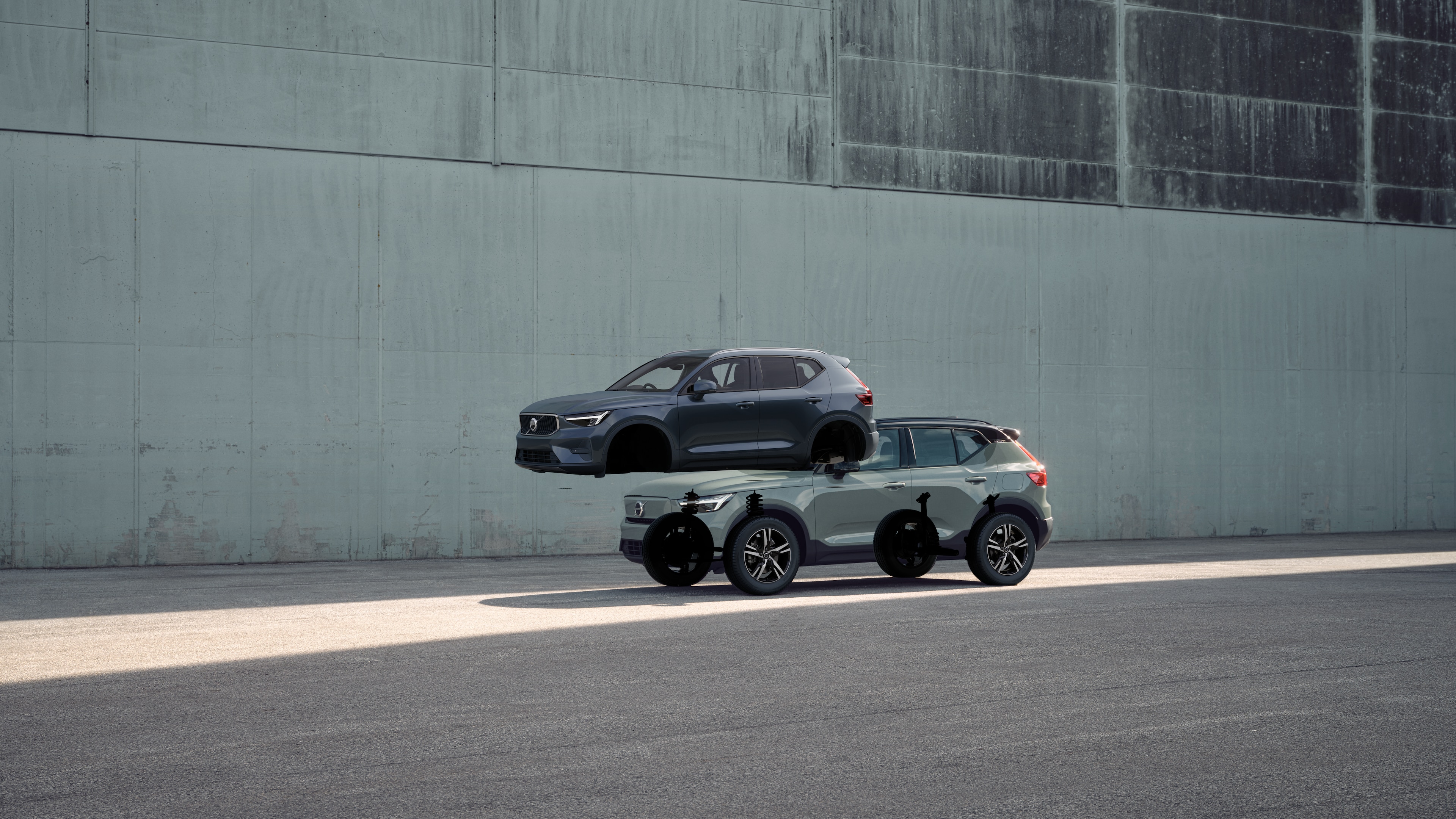 Volvo car exterior in three-quarter view against an industrial concrete wall background.