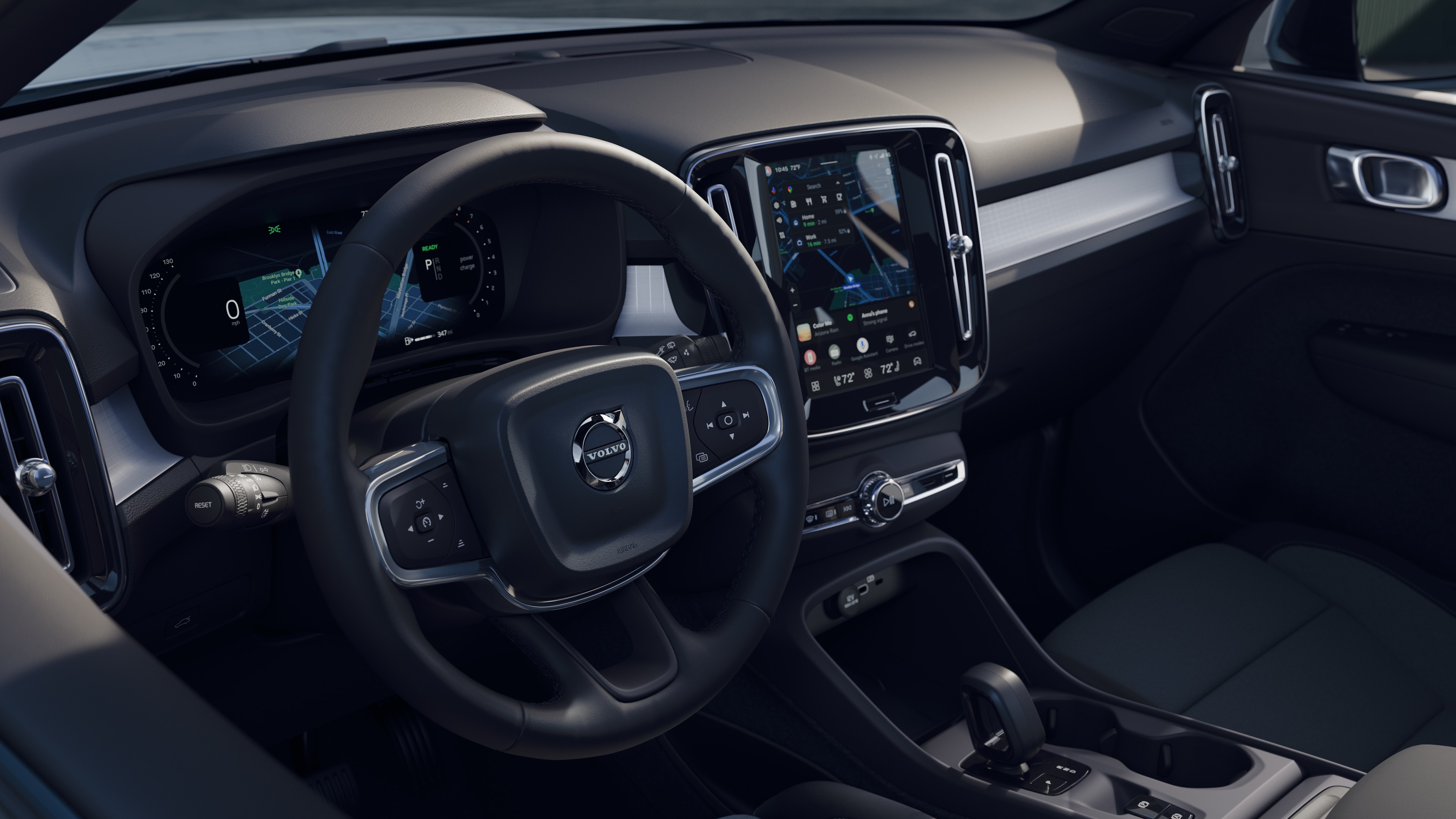 Volvo car interior showing dashboard, steering wheel, and center console with digital display in an open road background.