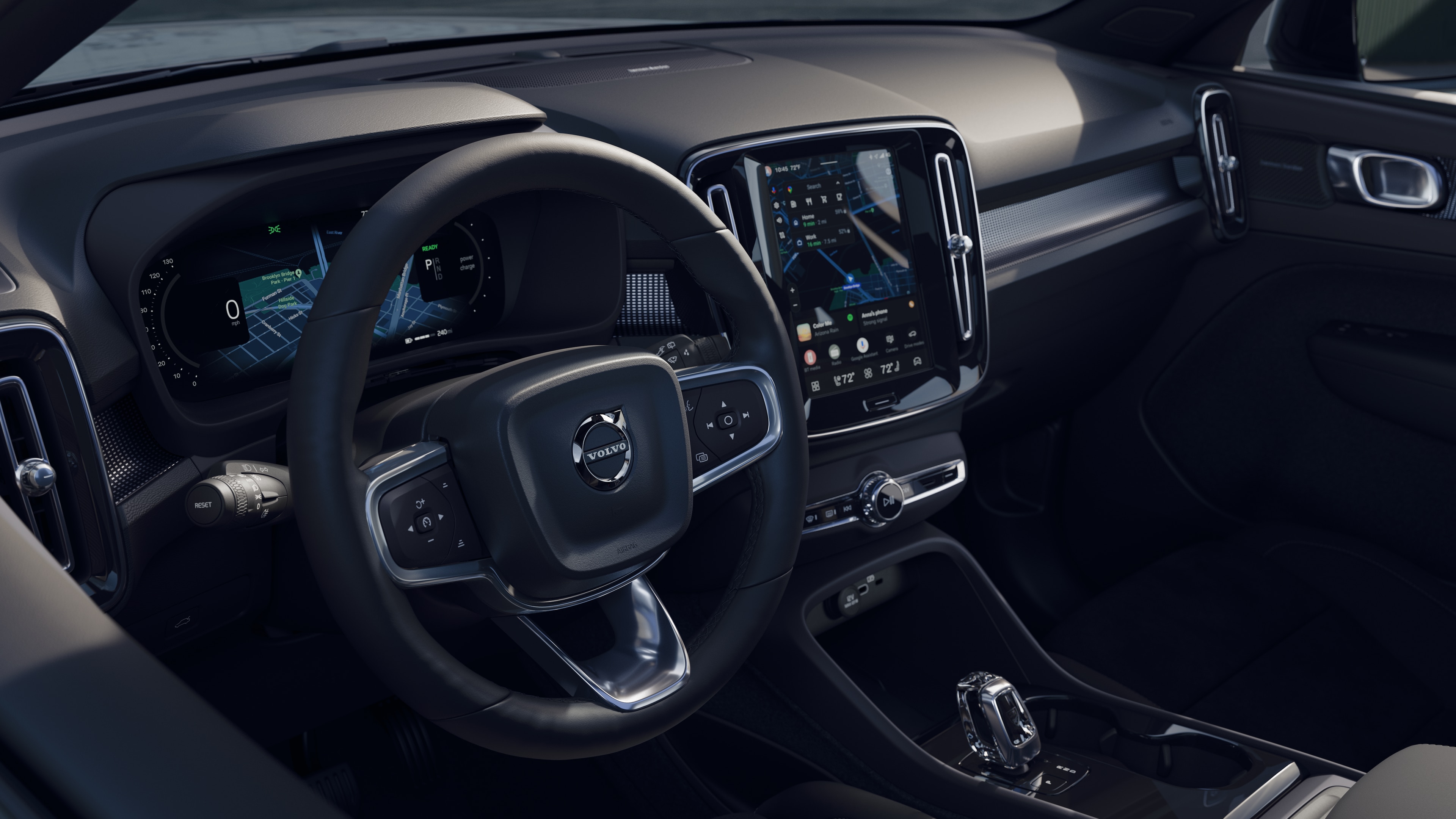 Volvo car interior showing dashboard, steering wheel, and center console with digital display in an open road background.