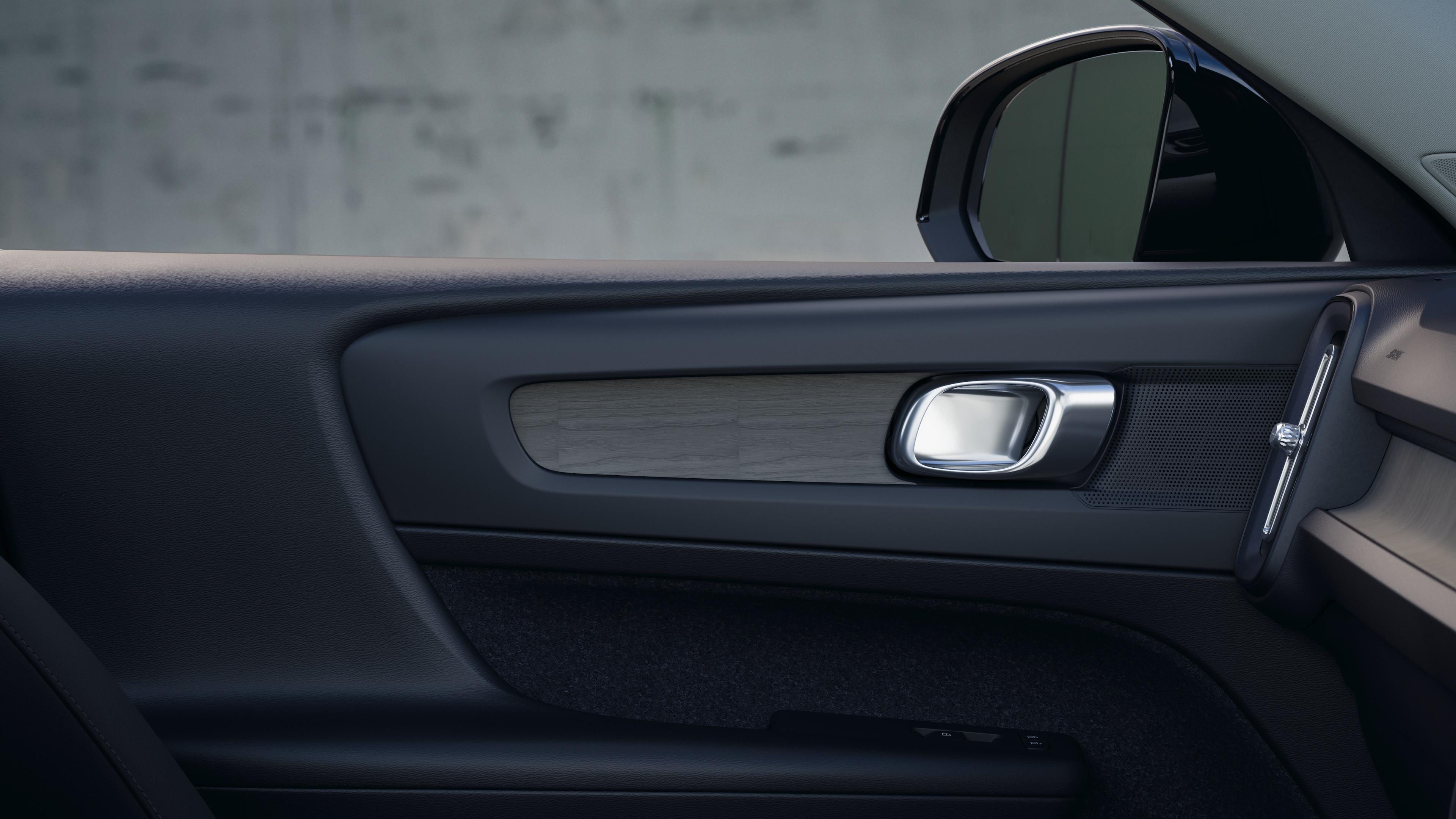 Volvo car interior showing front and rear passenger seats, steering wheel, dashboard, and center console against a plain studio background.