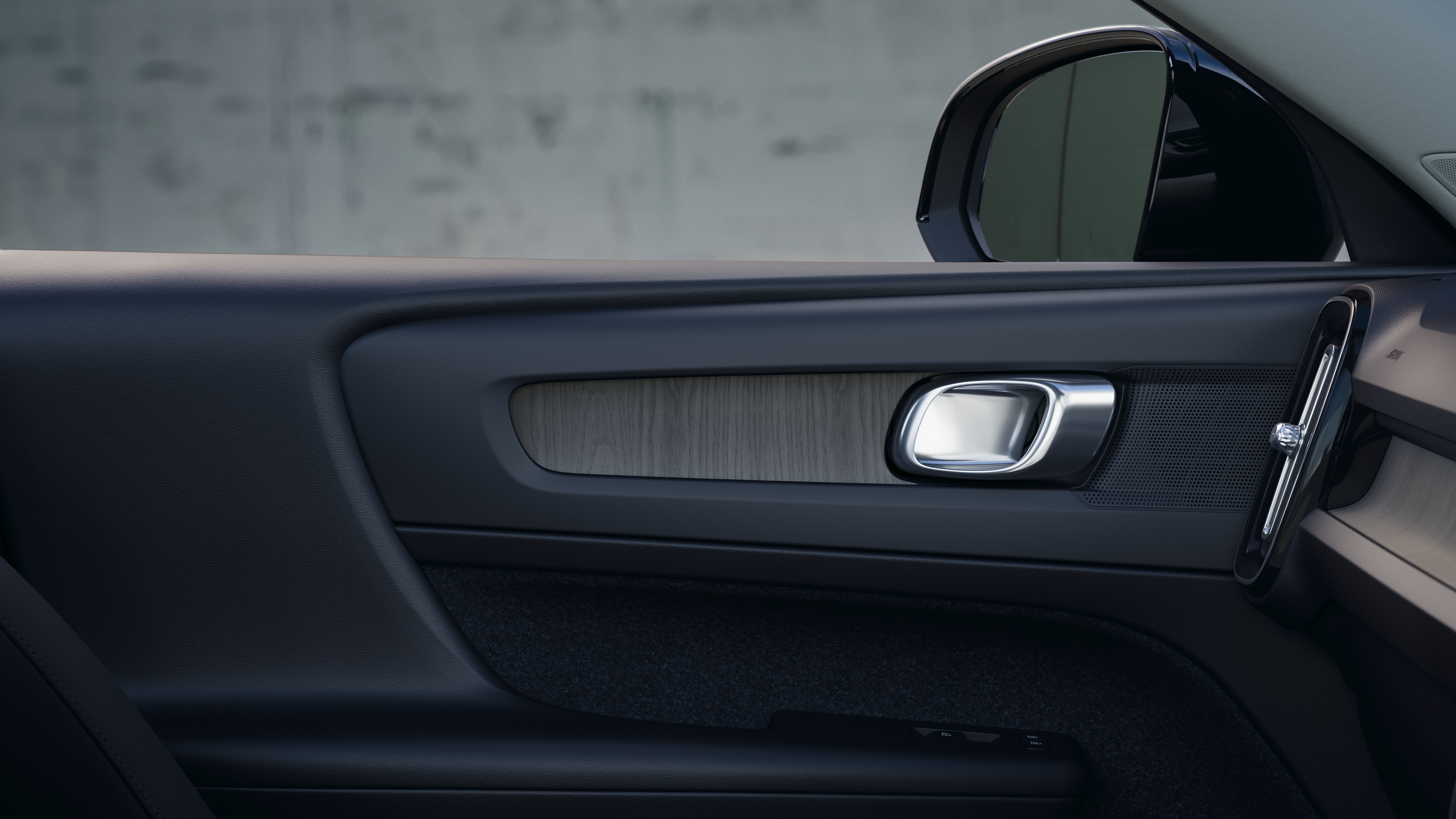 Volvo car interior showing front and rear passenger seats, steering wheel, dashboard, and center console against a plain studio background.