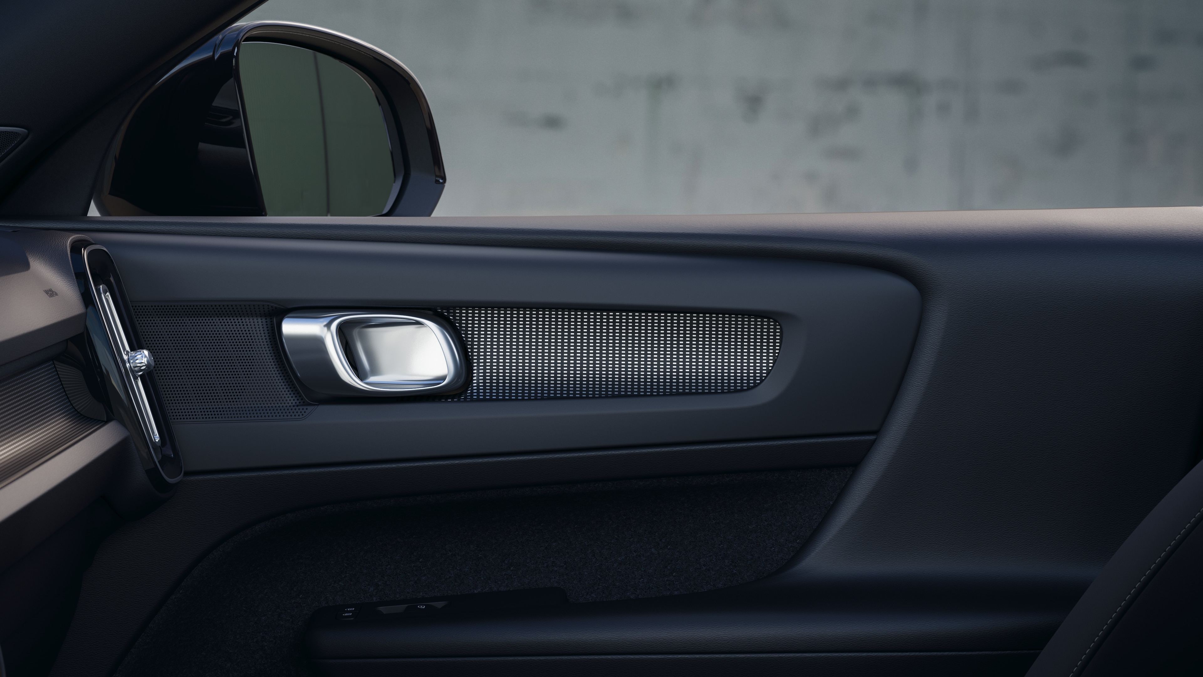 Volvo car interior showing front and rear passenger seats, steering wheel, dashboard, and center console against a plain studio background.