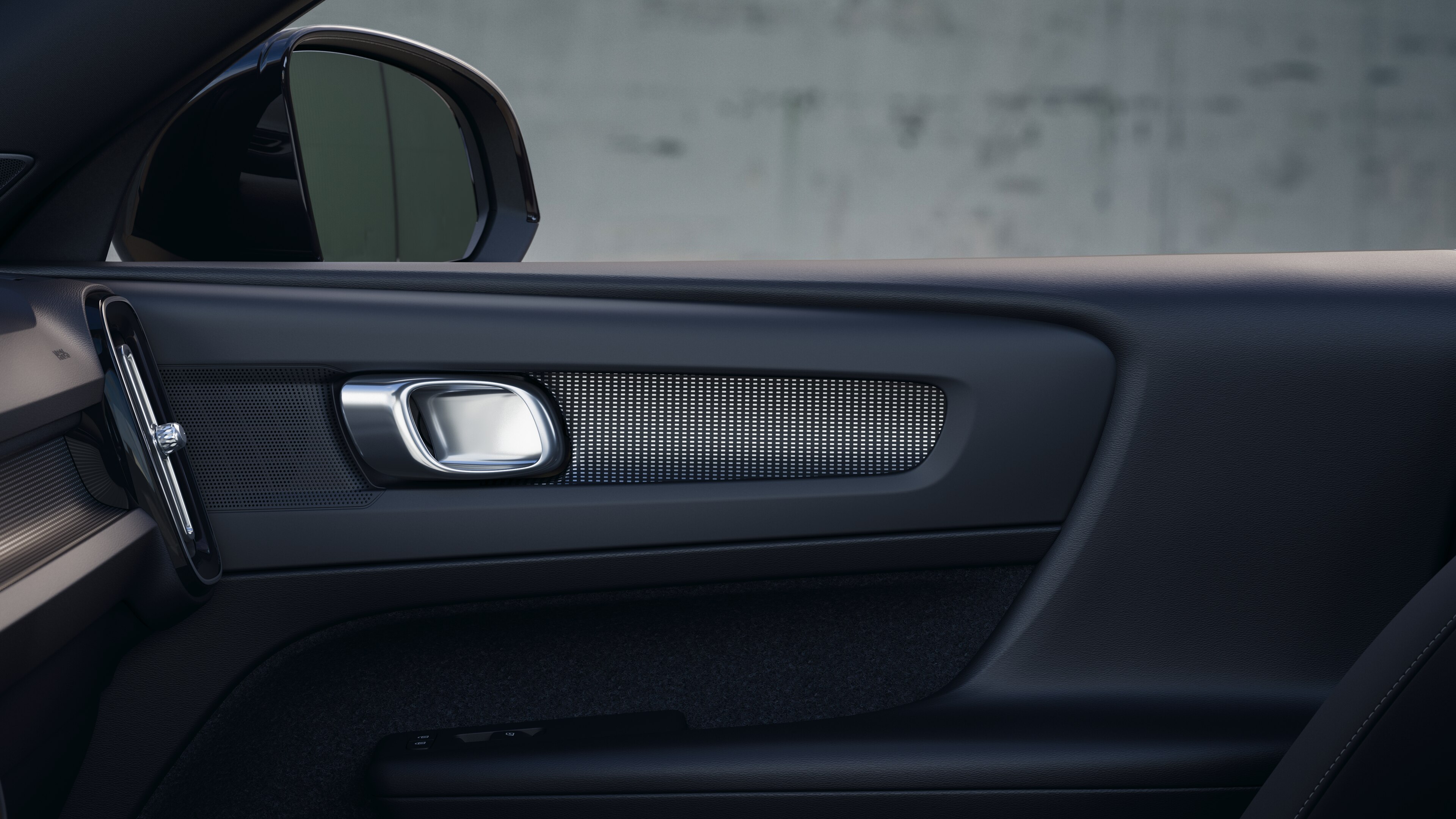 Volvo car interior showing front and rear passenger seats, steering wheel, dashboard, and center console against a plain studio background.