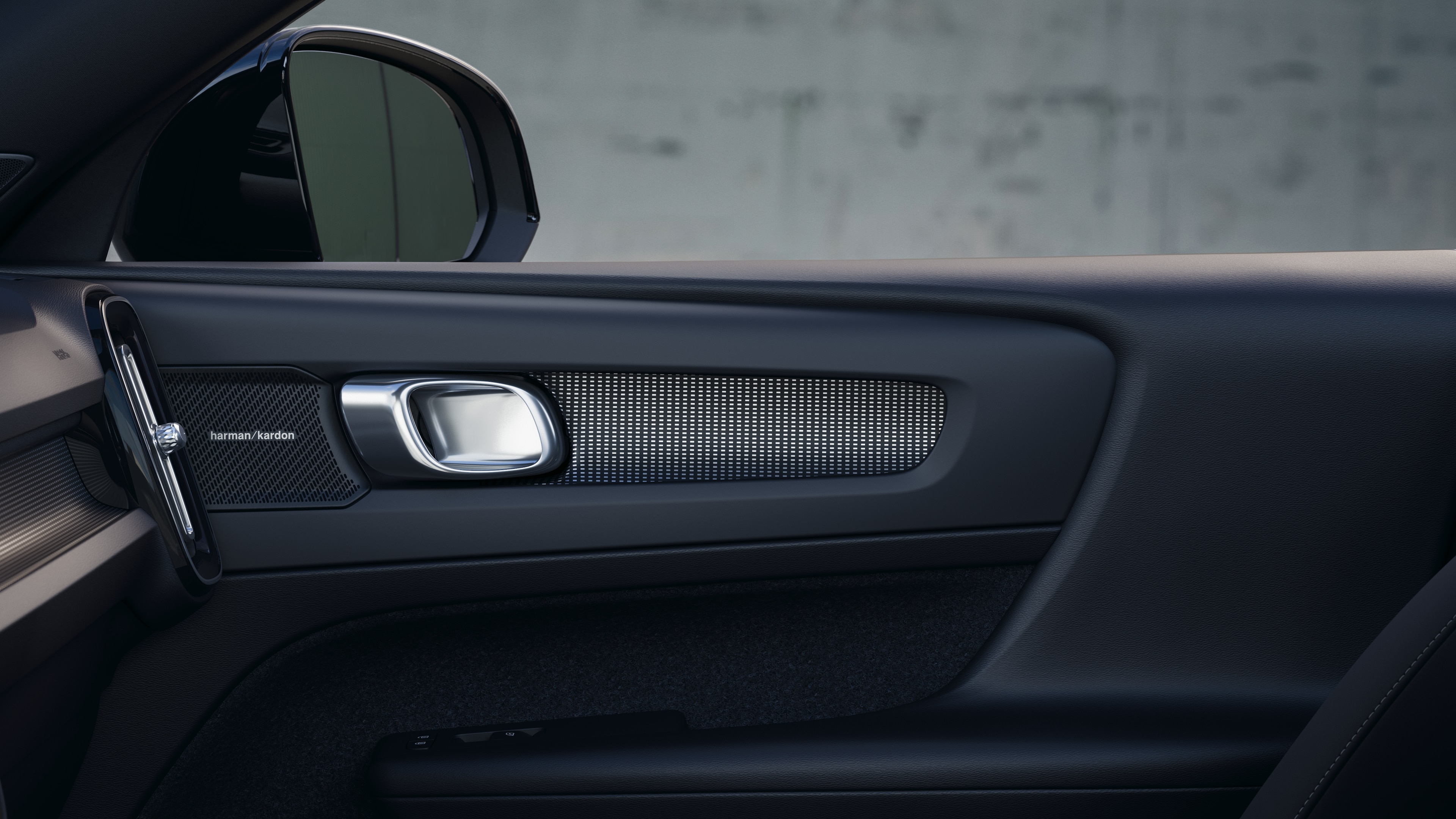 Volvo car interior showing front and rear passenger seats, steering wheel, dashboard, and center console against a plain studio background.