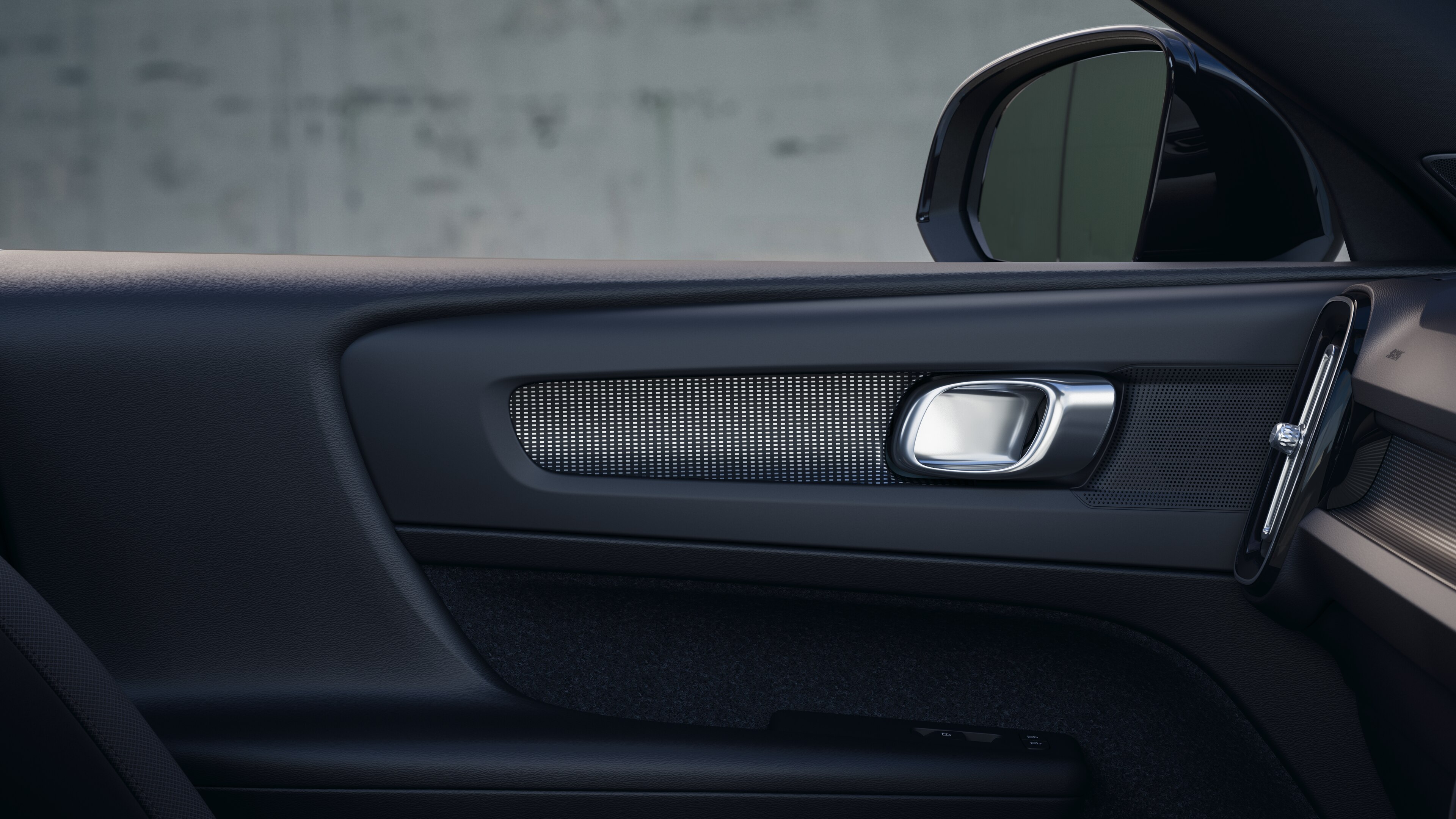 Volvo car interior showing front and rear passenger seats, steering wheel, dashboard, and center console against a plain studio background.