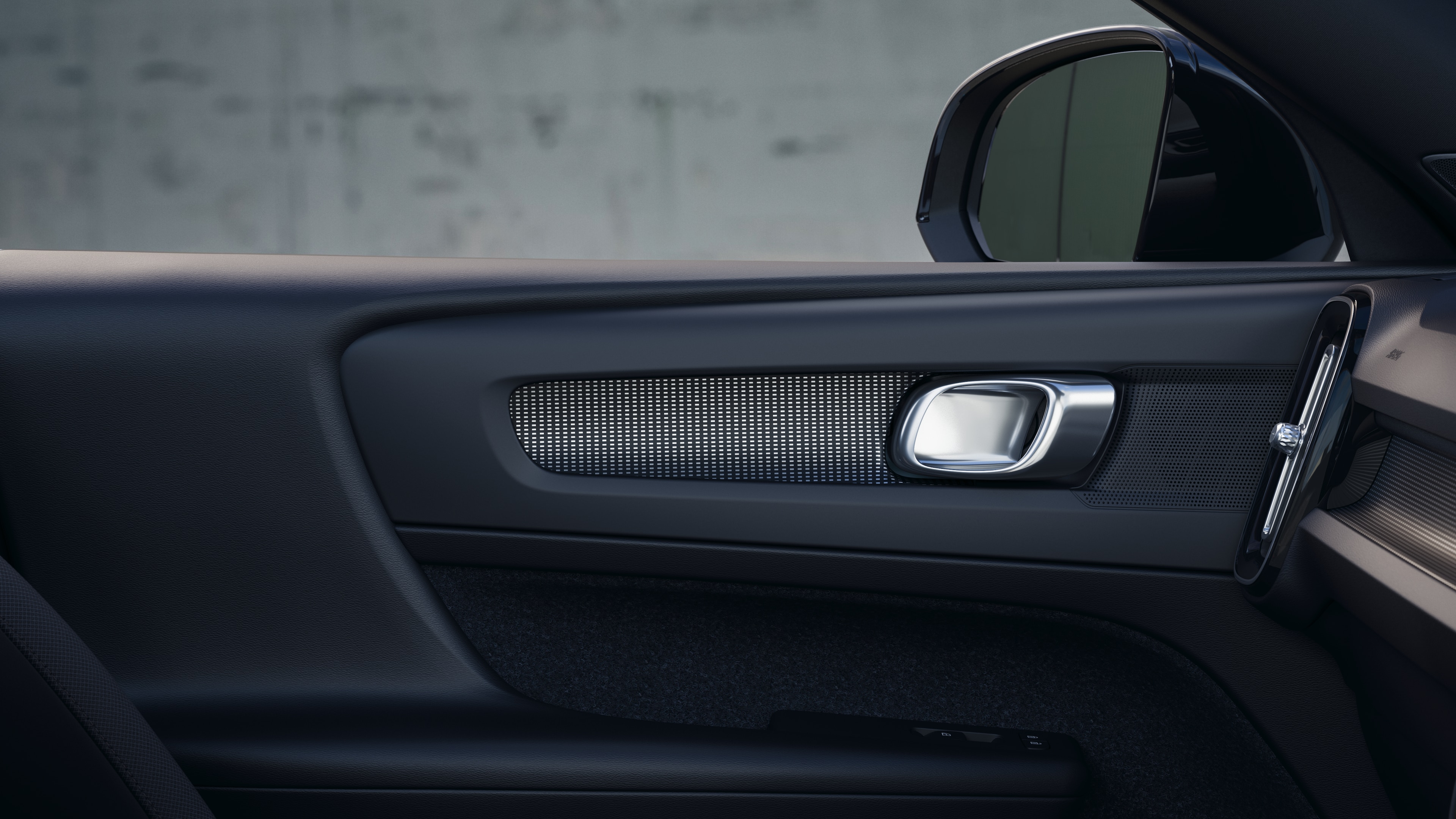 Volvo car interior showing front and rear passenger seats, steering wheel, dashboard, and center console against a plain studio background.