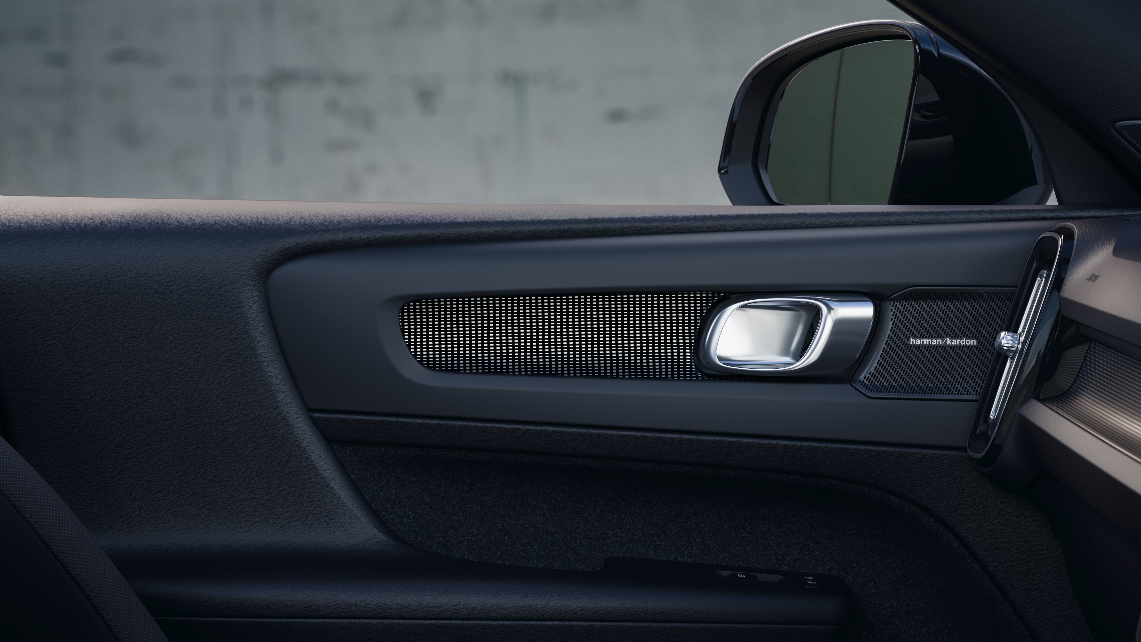 Volvo car interior showing front and rear passenger seats, steering wheel, dashboard, and center console against a plain studio background.