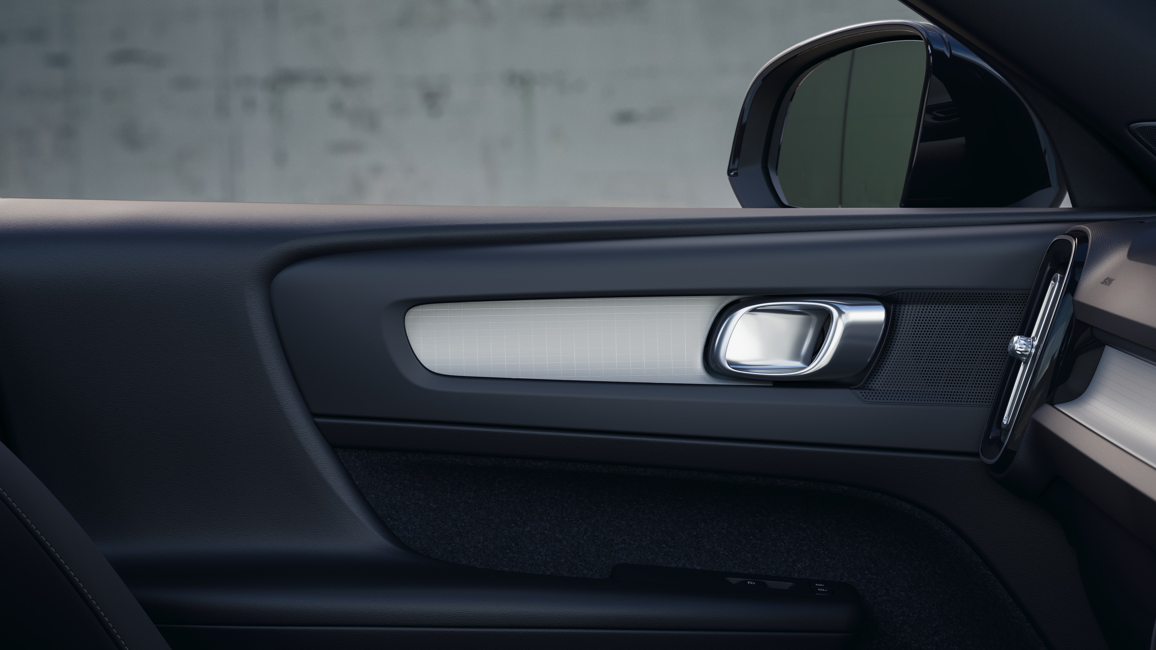 Volvo car interior showing front and rear passenger seats, steering wheel, dashboard, and center console against a plain studio background.